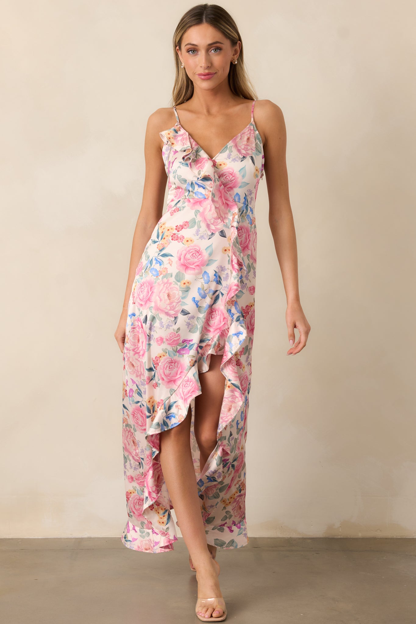 A stunning pink maxi dress with a V-neckline, ruffle accents, and an elegant floral design, perfect for any occasion.