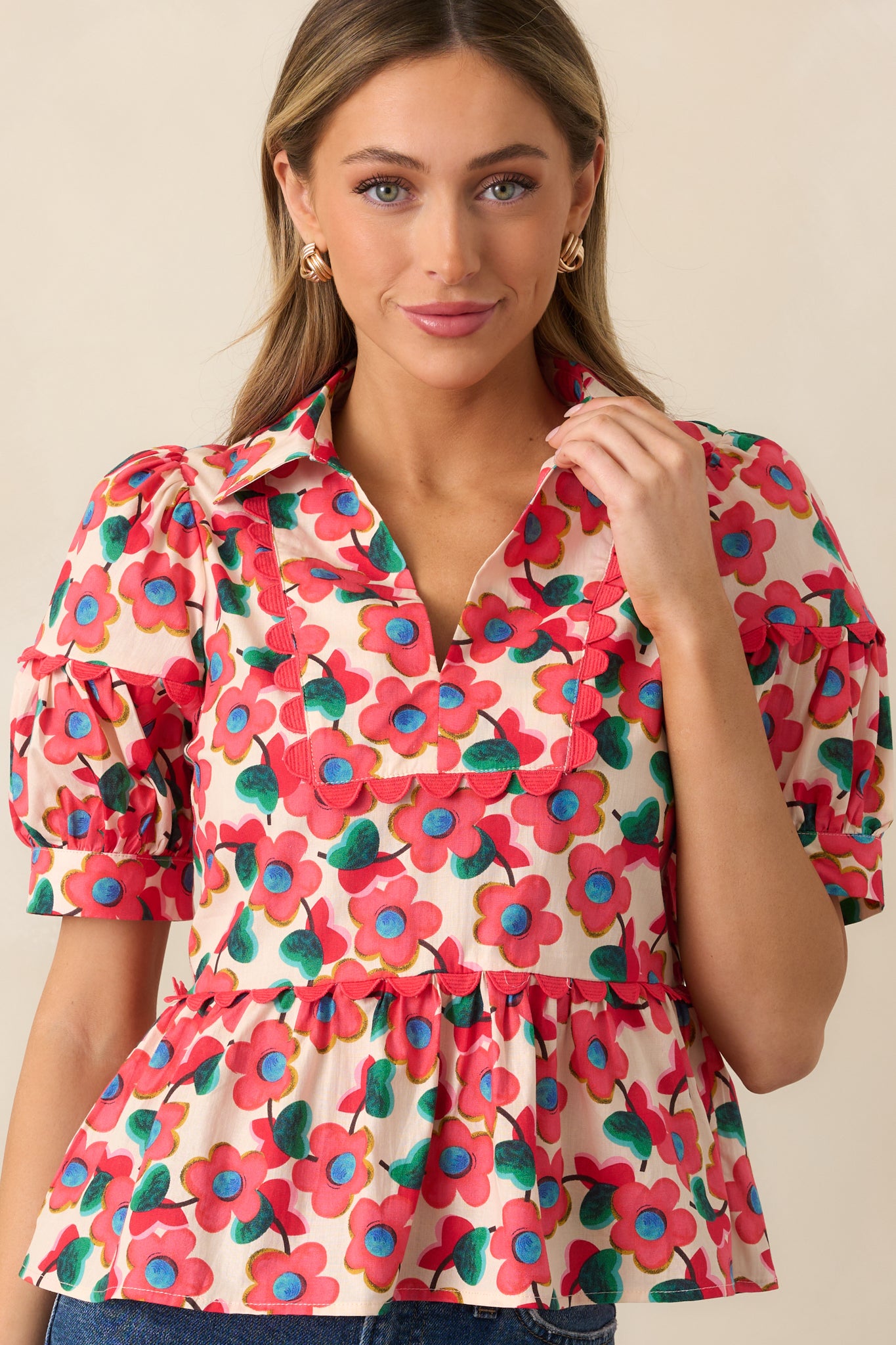 A closer look at the upper portion of the top, showcasing the collared V-neckline and floral pattern.