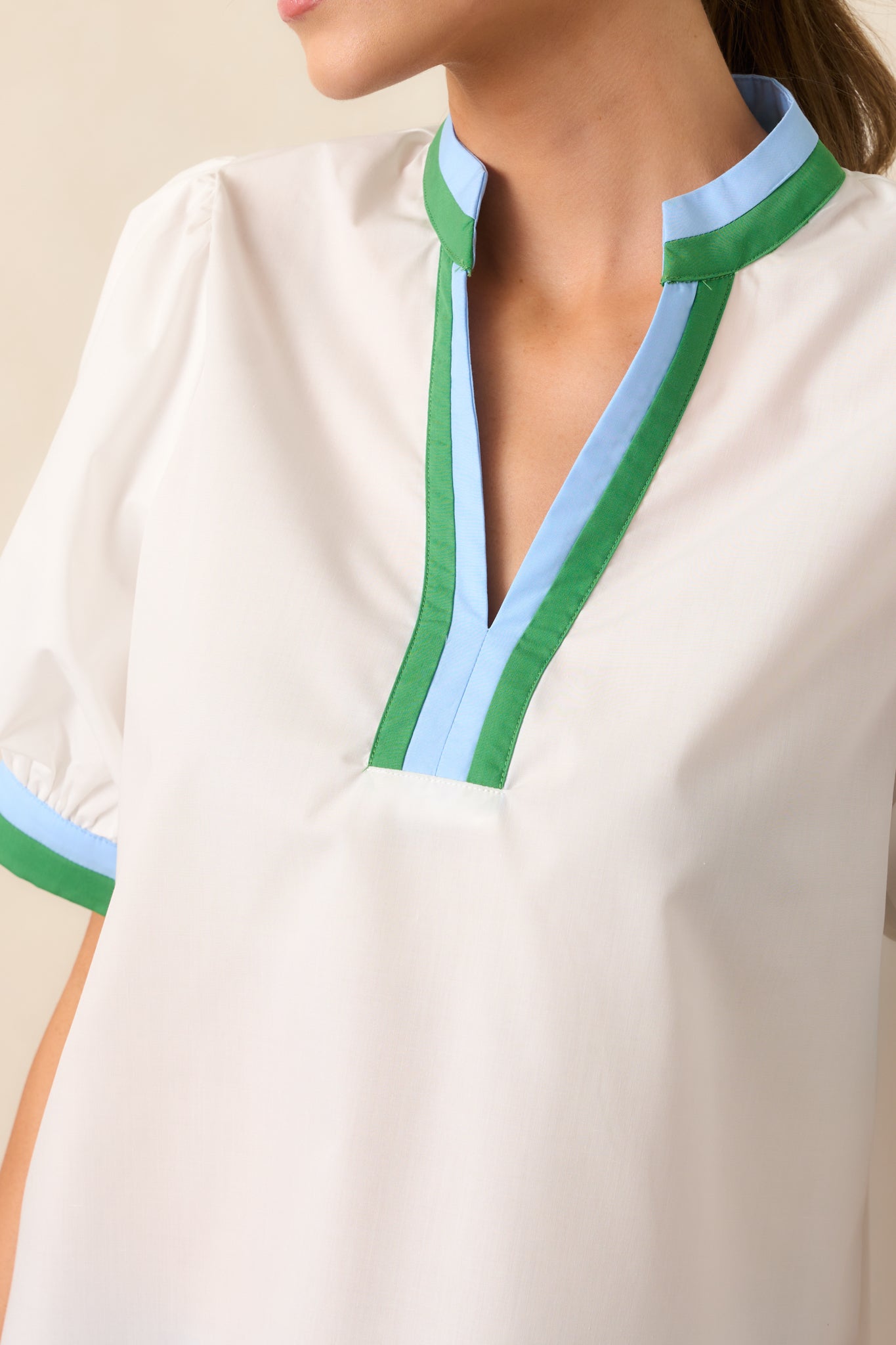 A zoomed-in view of the green and blue stripe hem, showcasing the contrast design and stitching.