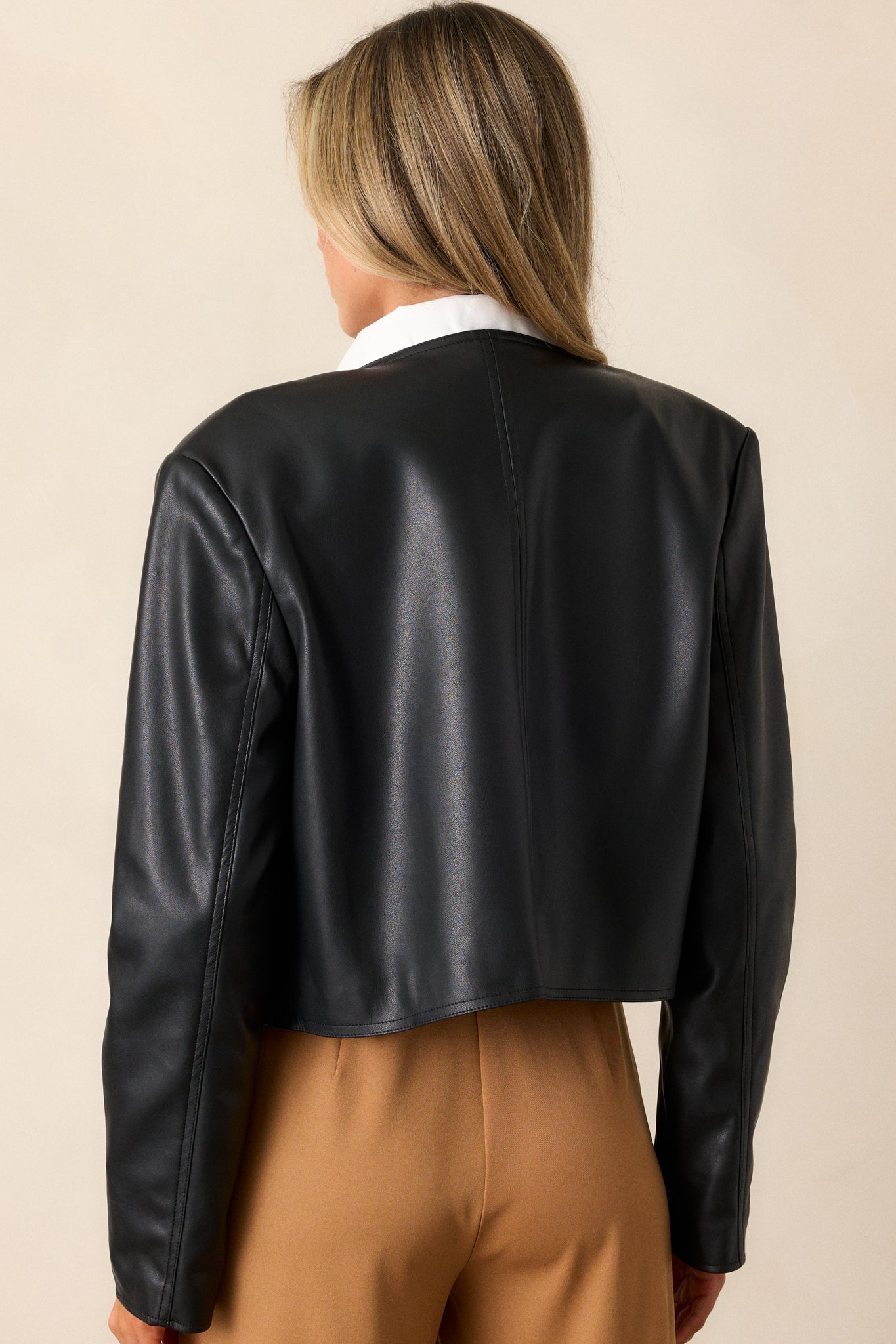 Back view of the jacket, emphasizing the clean lines and the structured look of the cropped length, designed for a chic and modern appearance.