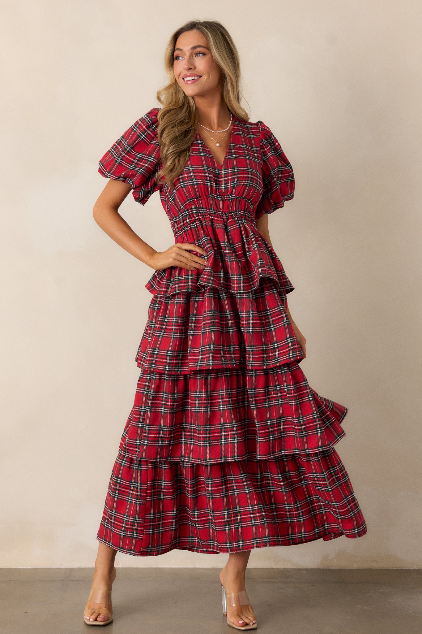 Full-length shot showcasing the elastic waistband that accentuates the waist, flowing into the tiered maxi skirt with a beautiful plaid pattern.
