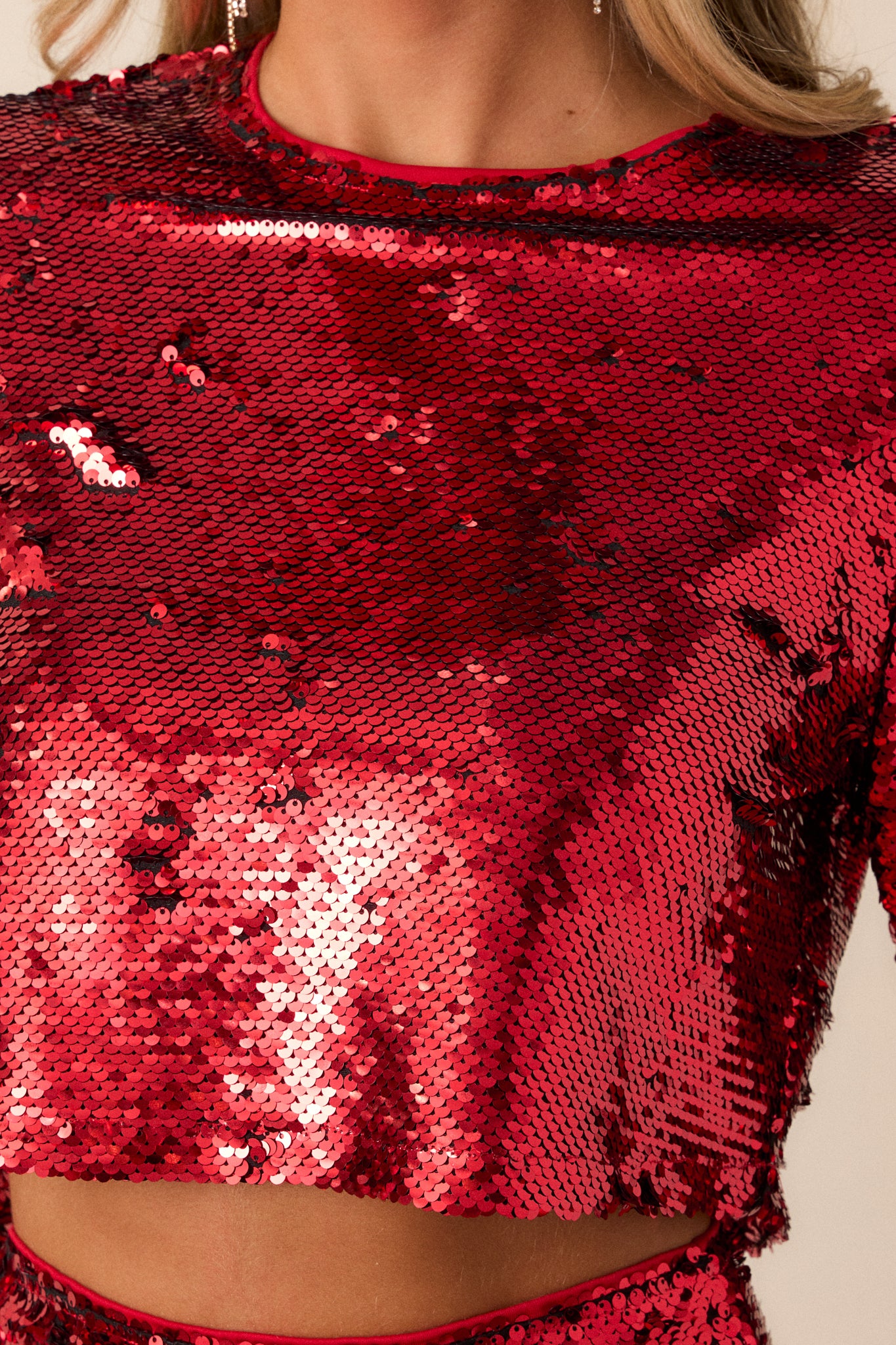 Close up view of this top that features an all over sequin flip design and long sleeves.