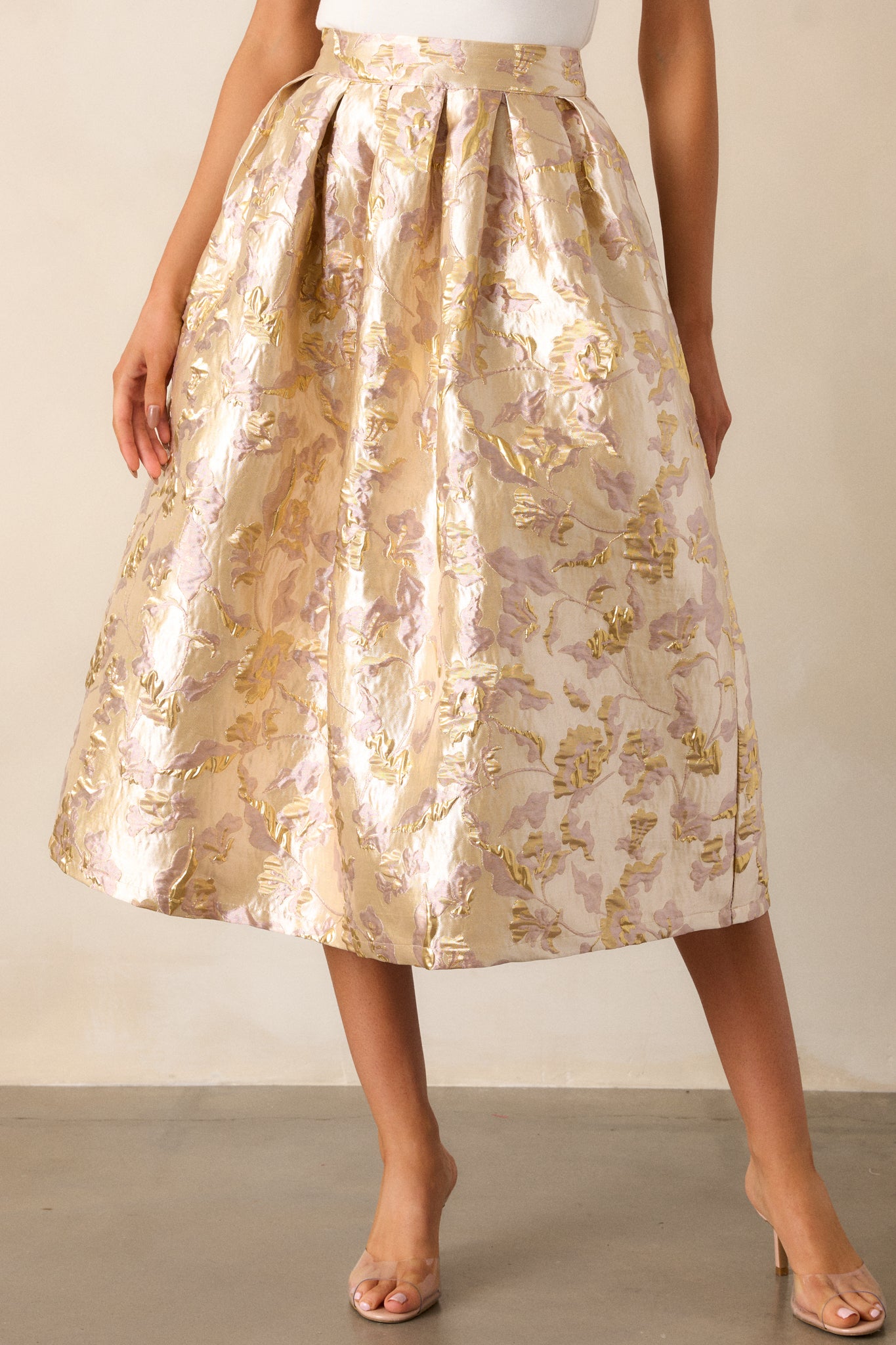 A cropped view focusing on the upper portion of the skirt, emphasizing the raised gold flower details and the high waist.