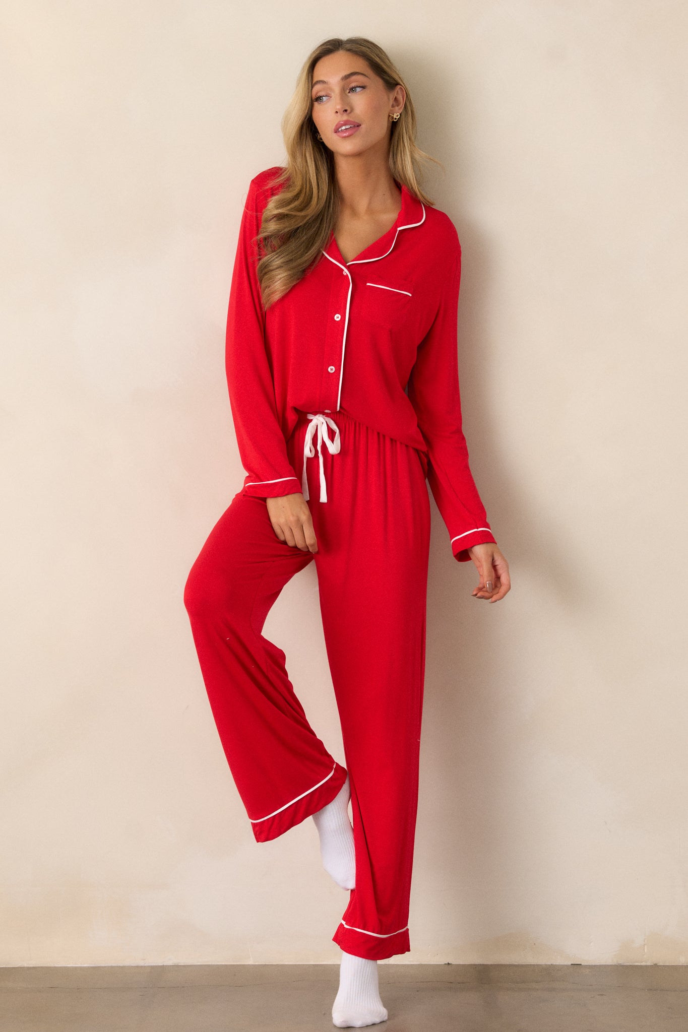 Red Pajama Pants featuring an elastic drawstring waistband with a white string, white trim detailing and long relaxed pant legs.