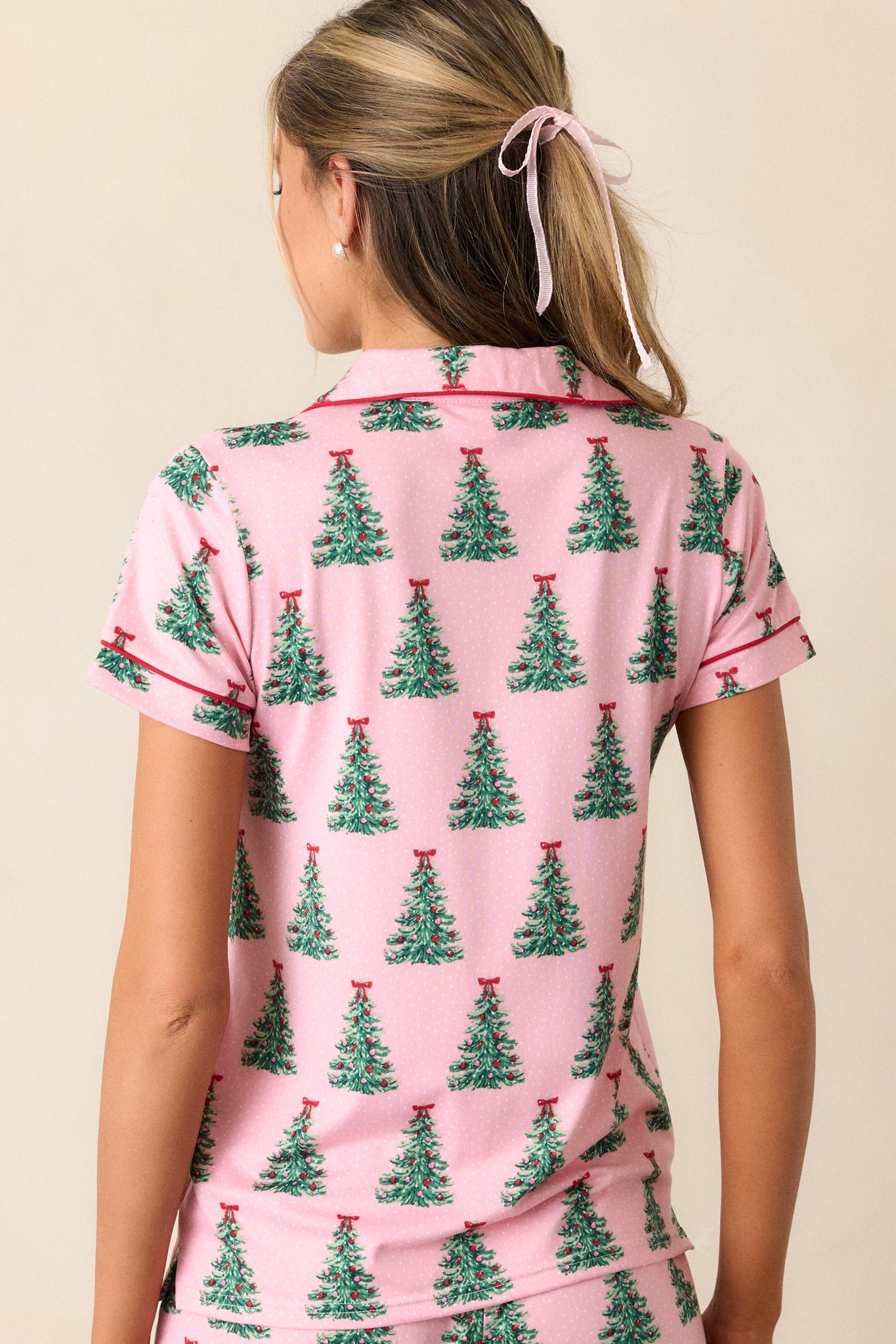 A back view of the pajama top, showing the continuation of the Christmas tree pattern and the simple, relaxed fit.