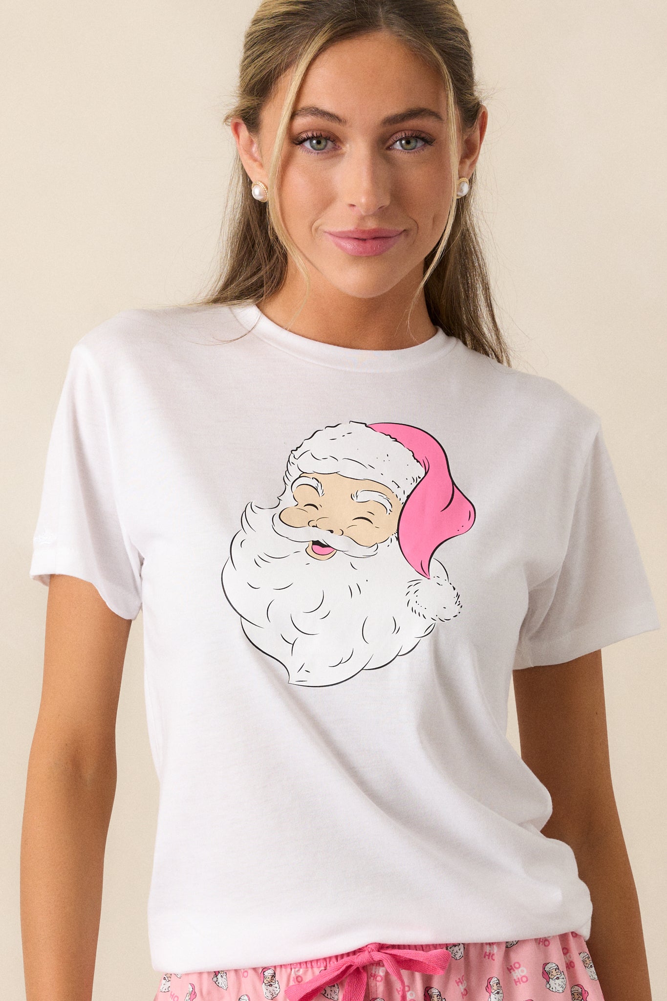 Front view of the pajama top emphasizing the rounded neckline and the playful Santa design, highlighting the casual style perfect for lounging.