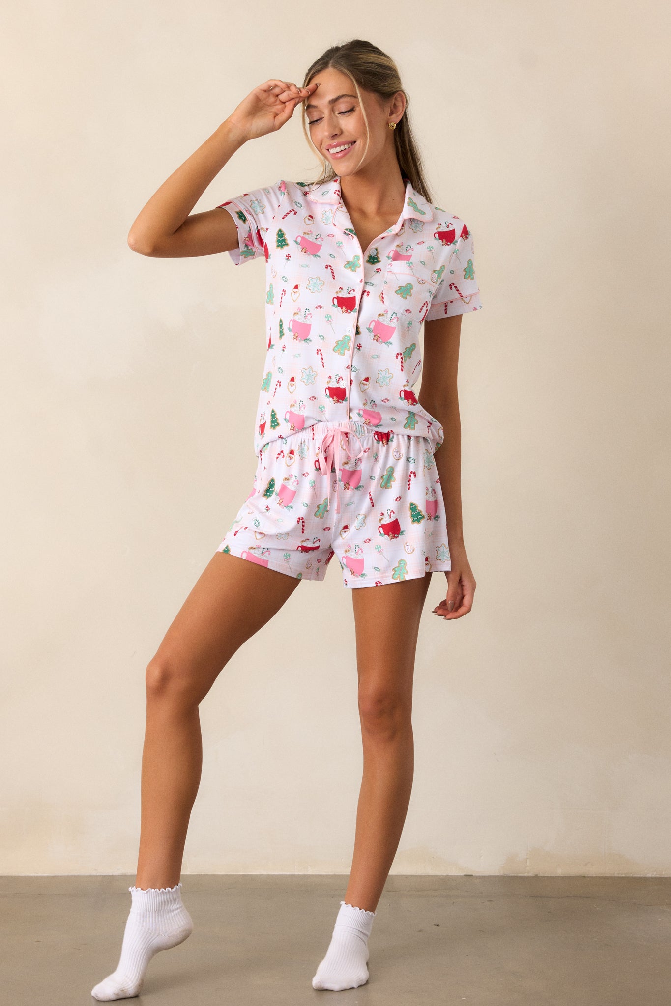 Full view of the ivory pajama shorts featuring an elastic drawstring waistband with a pink string, showcased in a relaxed fit against a neutral backdrop.