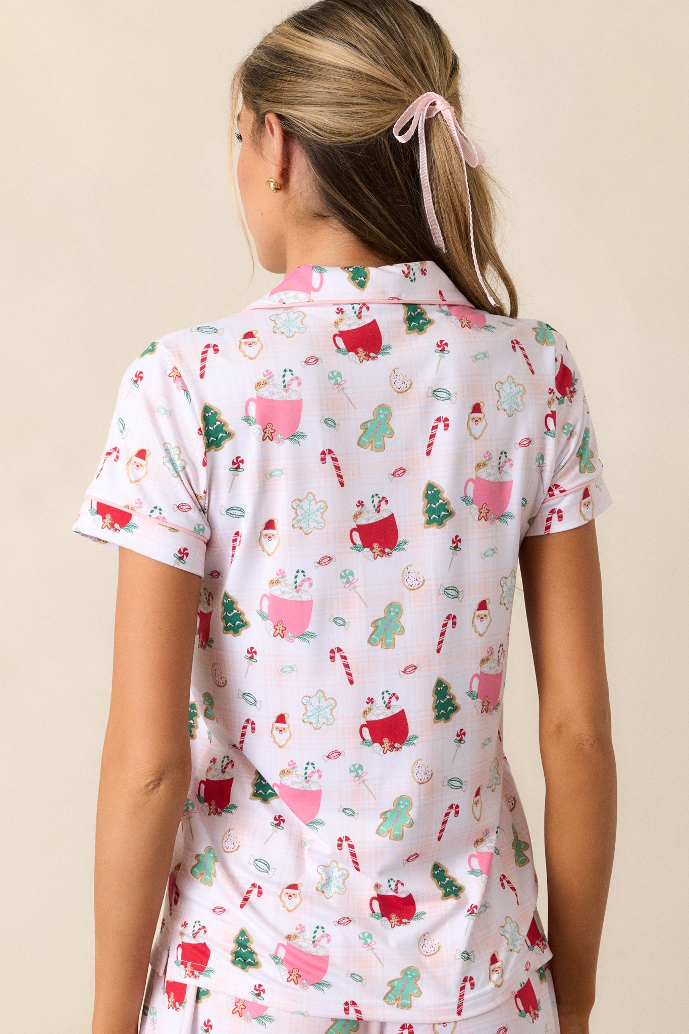 Back view of the top, displaying the short sleeves and the overall relaxed fit, along with the pink trim accenting the collar.