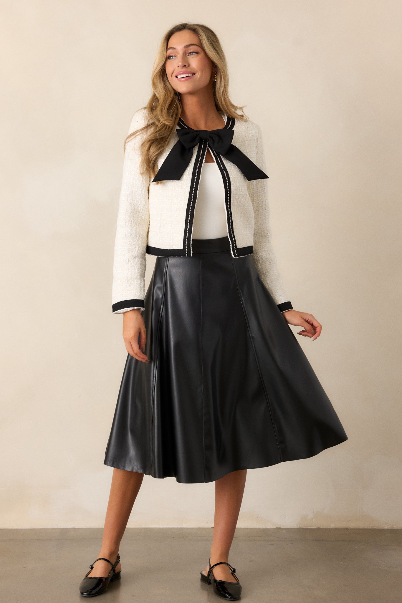 This skirt features an a-line design, stitch detailing on the seams, a side zipper, and stunning faux leather fabric.