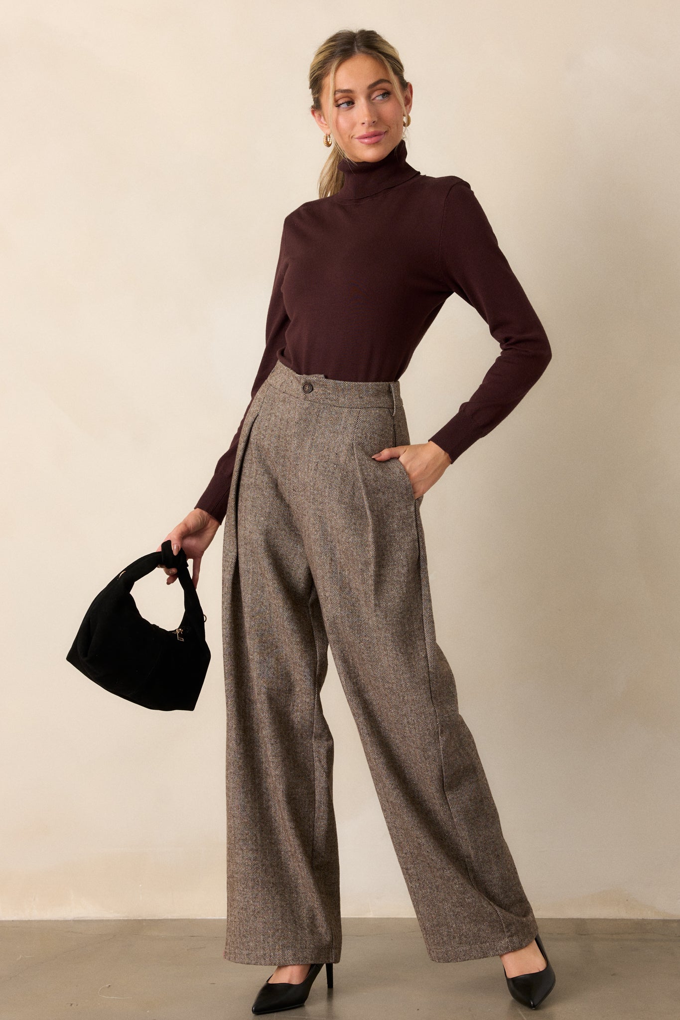 Full-length view of brown herringbone pants with functional belt loops and hidden zipper and button front, showing the structured fit from waist to hem.