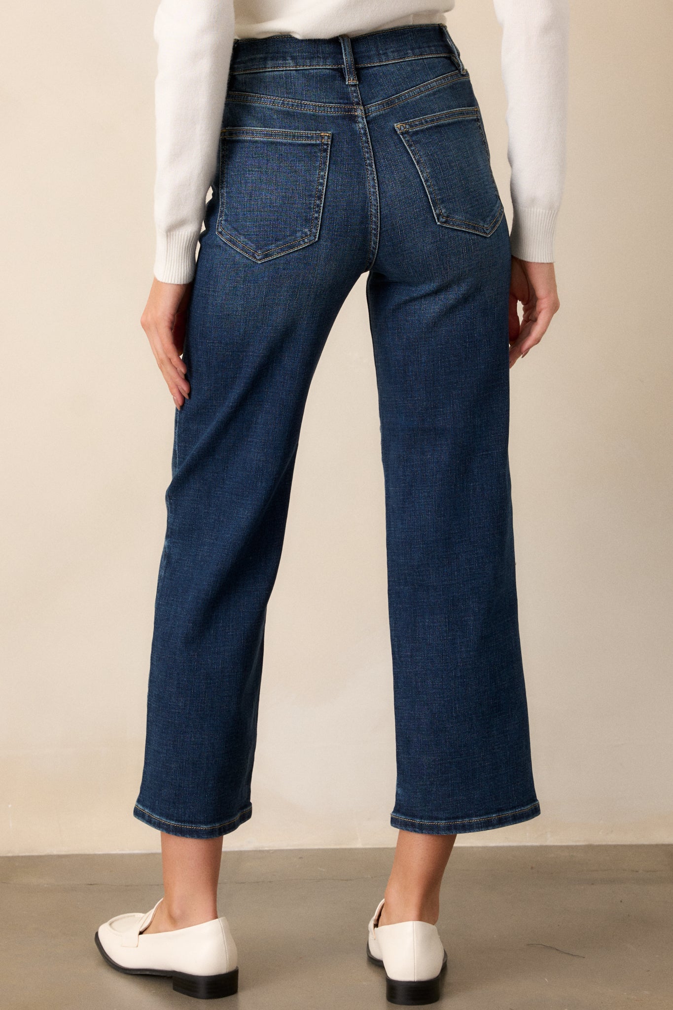 Rear view of the dark wash straight-leg jeans, focusing on the high waist and functional back pockets.