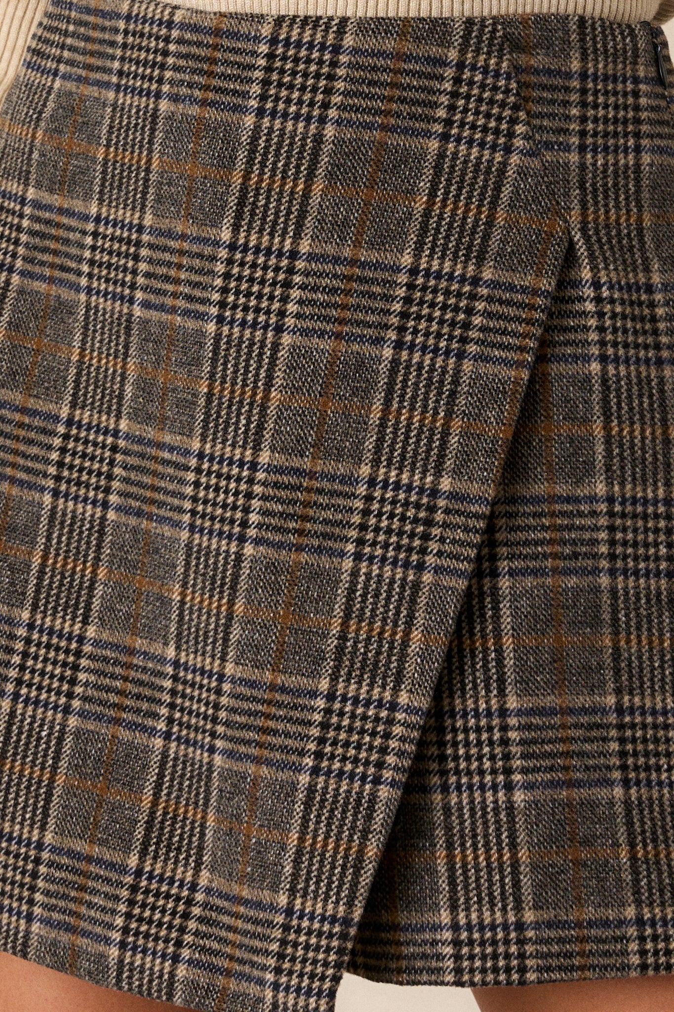 A close-up of the plaid design on the skort, highlighting the intricate patterns and fabric texture.