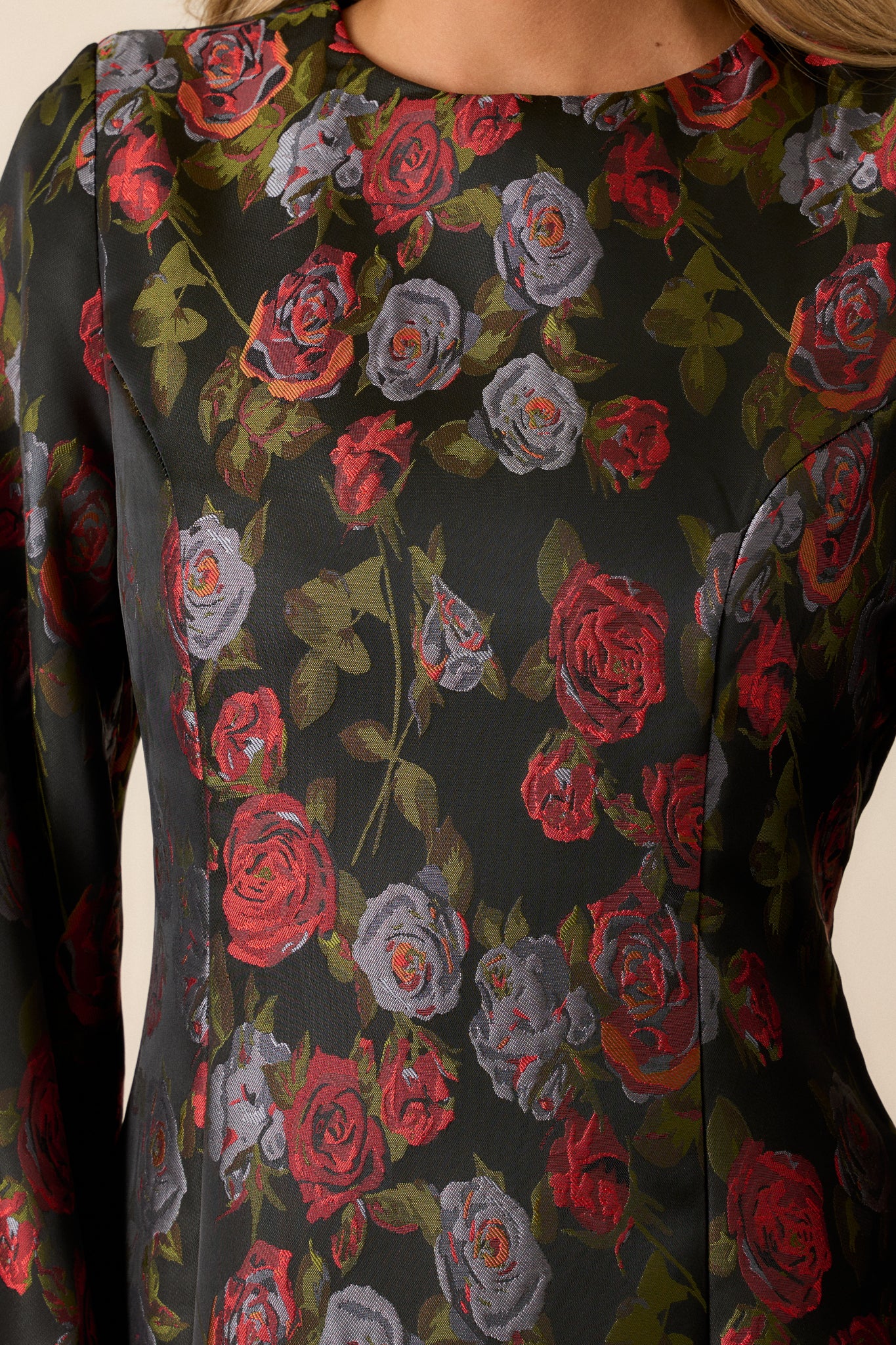 Close-up of the hidden zipper on the back of the black floral dress, emphasizing its sleek design and functionality.