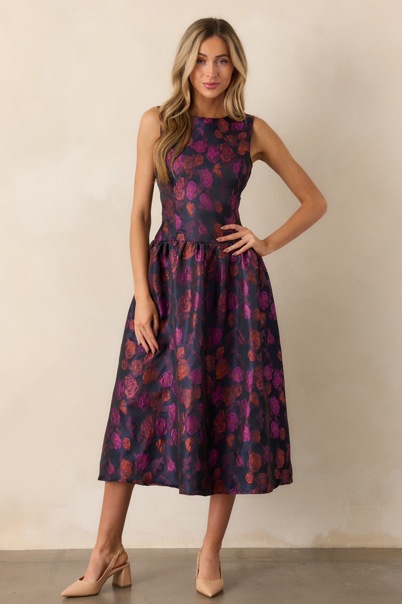 A front view of the purple dress, showcasing its flowing midi length and the beautiful floral pattern, perfect for any occasion.