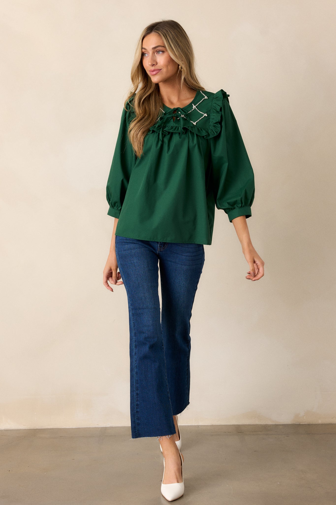 The hunter green top displayed in full view, highlighting the elegant 3/4 length puff sleeves and the overall flattering silhouette.