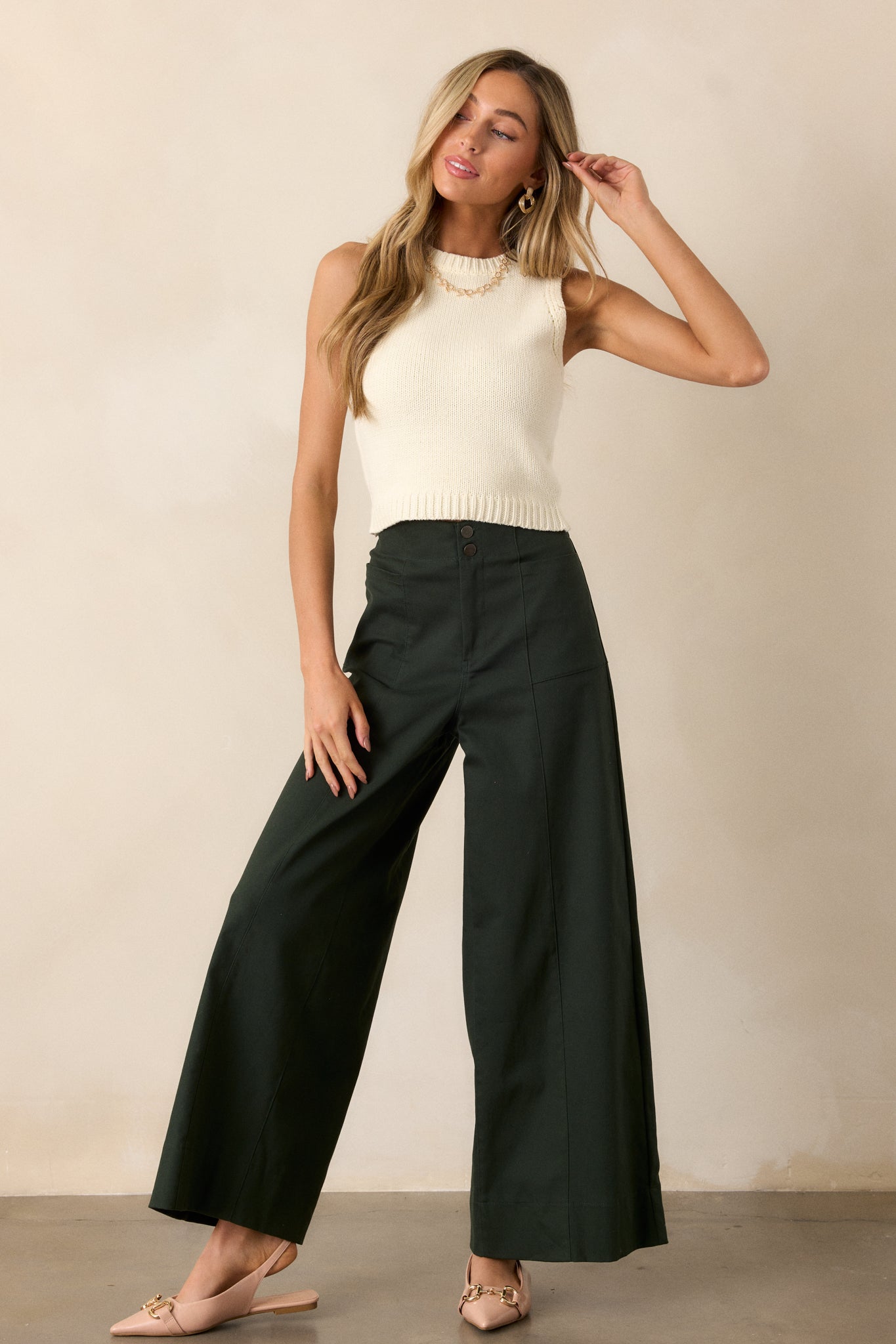 A full body view of the forest green pants showcasing the high-waisted design, highlighting the elegant fit and flow of the wide leg silhouette.