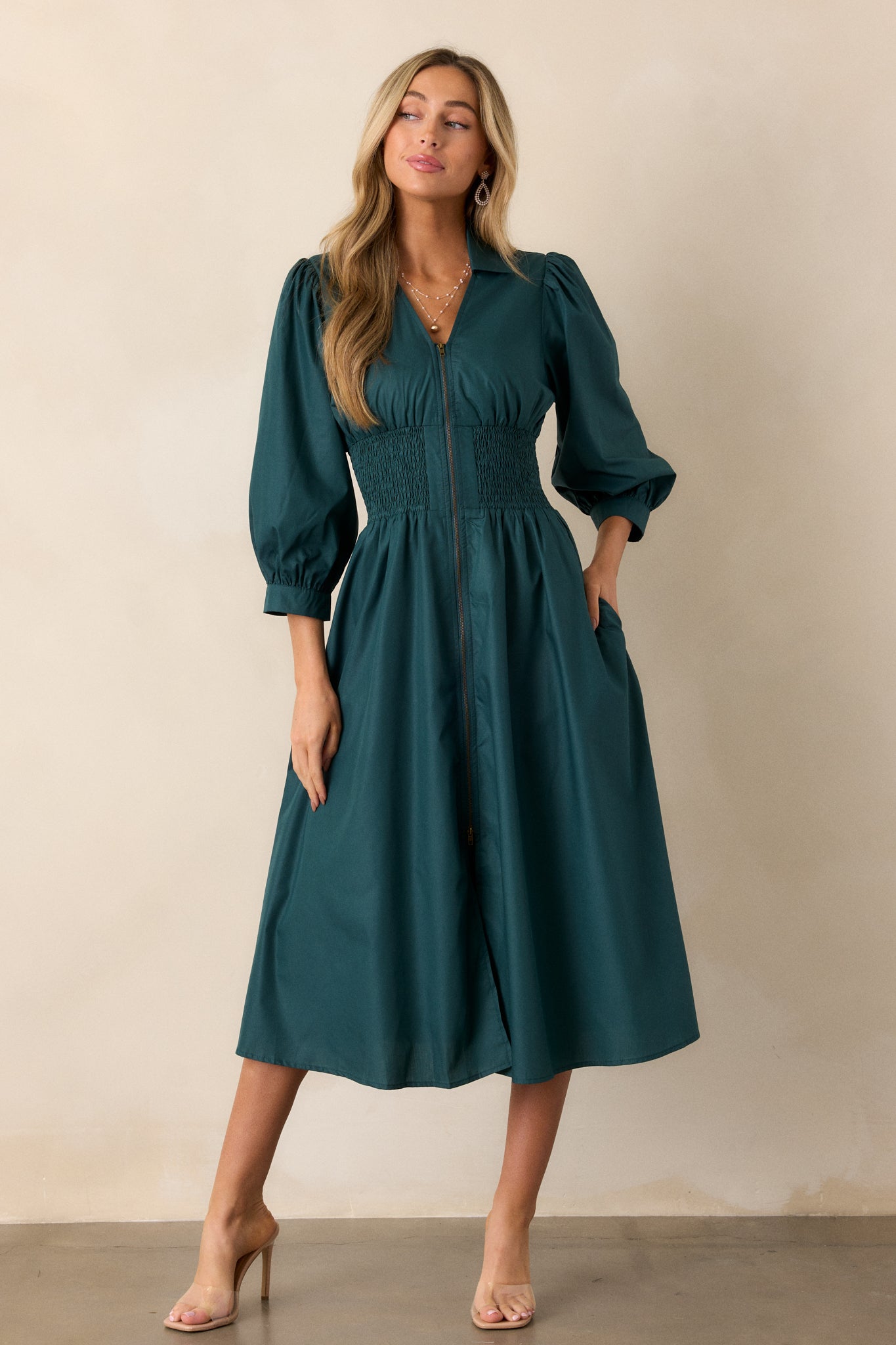 Full view of the forest green midi dress featuring a collared v-neckline, 3/4 sleeves with cuff detailing, and a functional front zipper with brassy gold hardware.