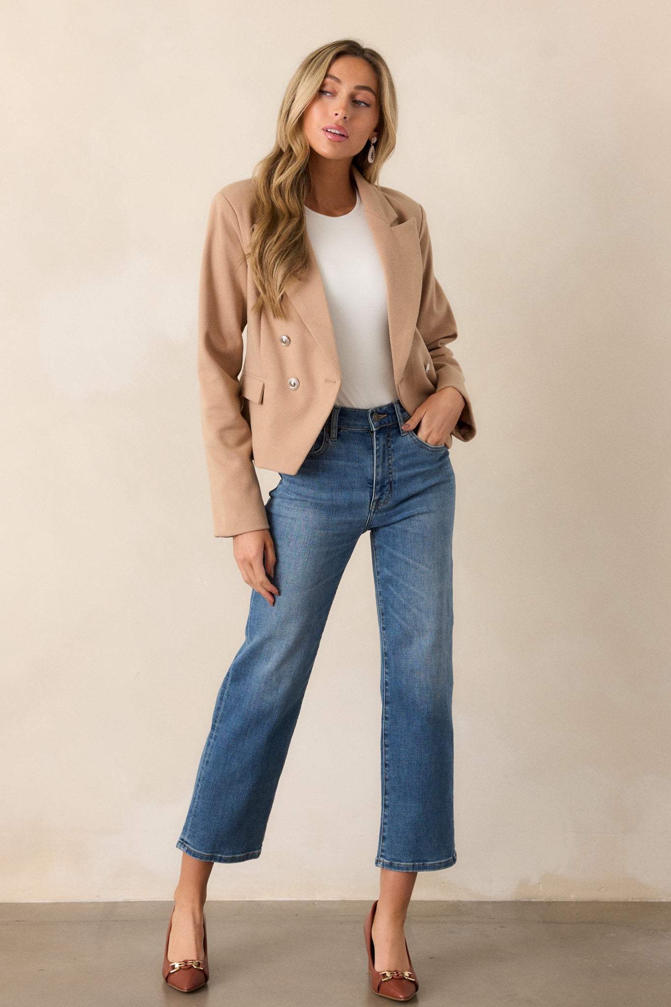 Full body view of medium wash straight leg jeans featuring a high waist design, functional front & back pockets, a button & zipper closure, and a straight leg.