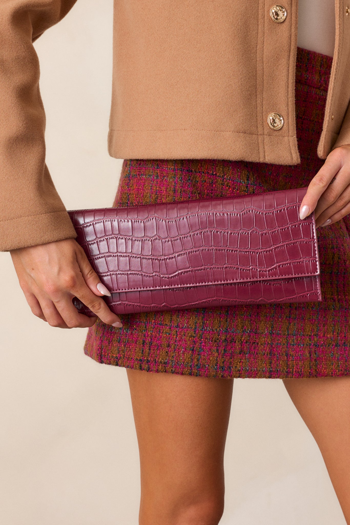 A full view of the wine-colored rectangular clutch, highlighting the faux crocodile texture, magnetic flap closure, and the structured shape.