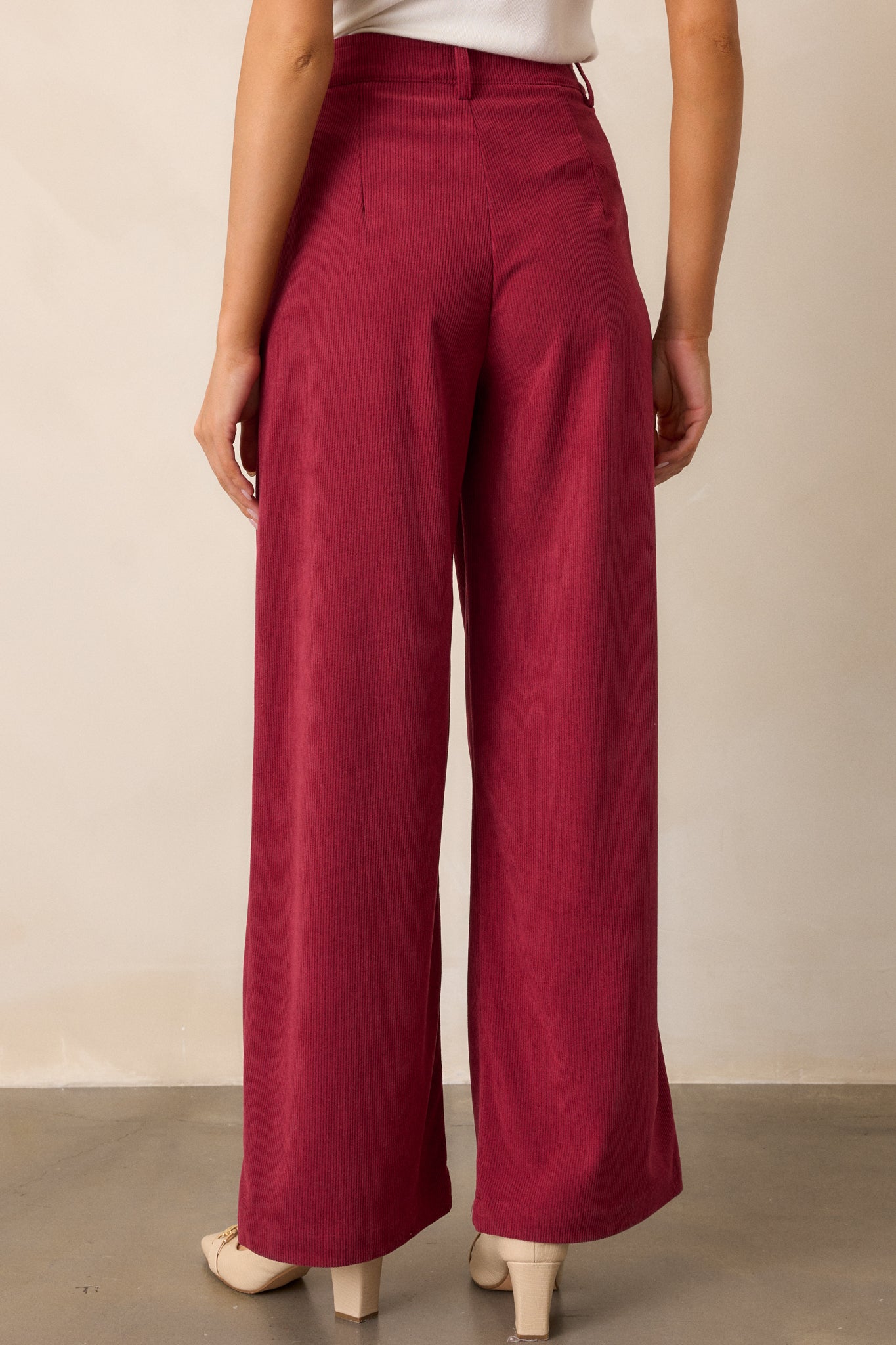 Back view of cranberry pants, showcasing the smooth material and relaxed fit from behind.