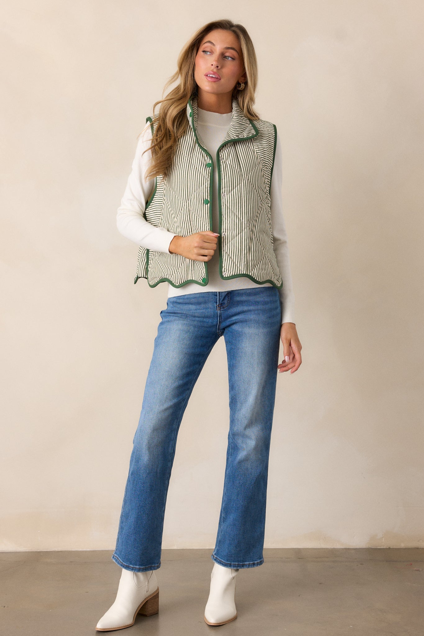 Green vest with a collared neckline and button front featuring snap buttons, showing the quilted pattern with stripe detailing throughout.