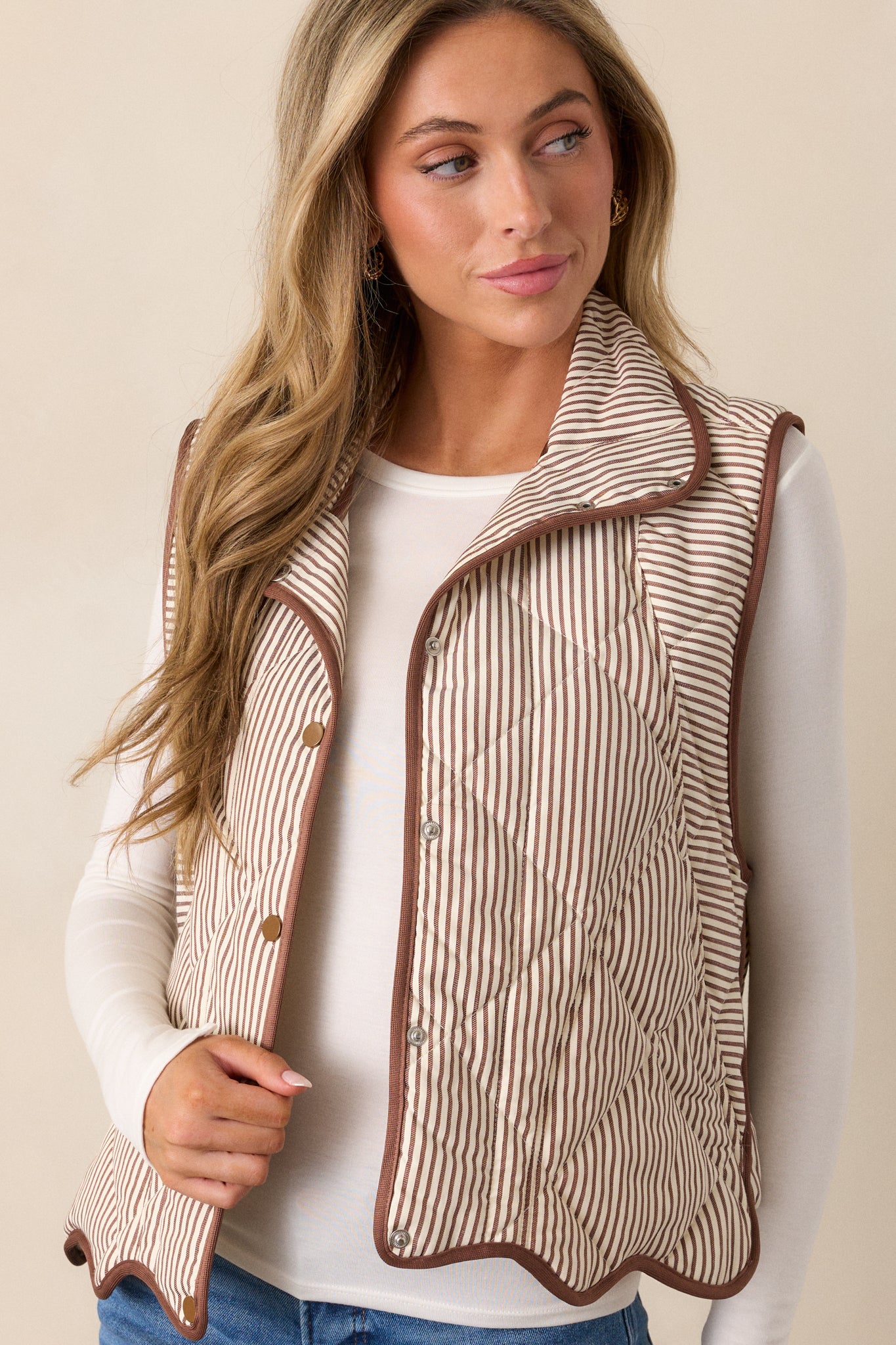 Close-up of the vest’s collared neckline and snap-button front, showcasing the quilted stripe detailing across the chest.