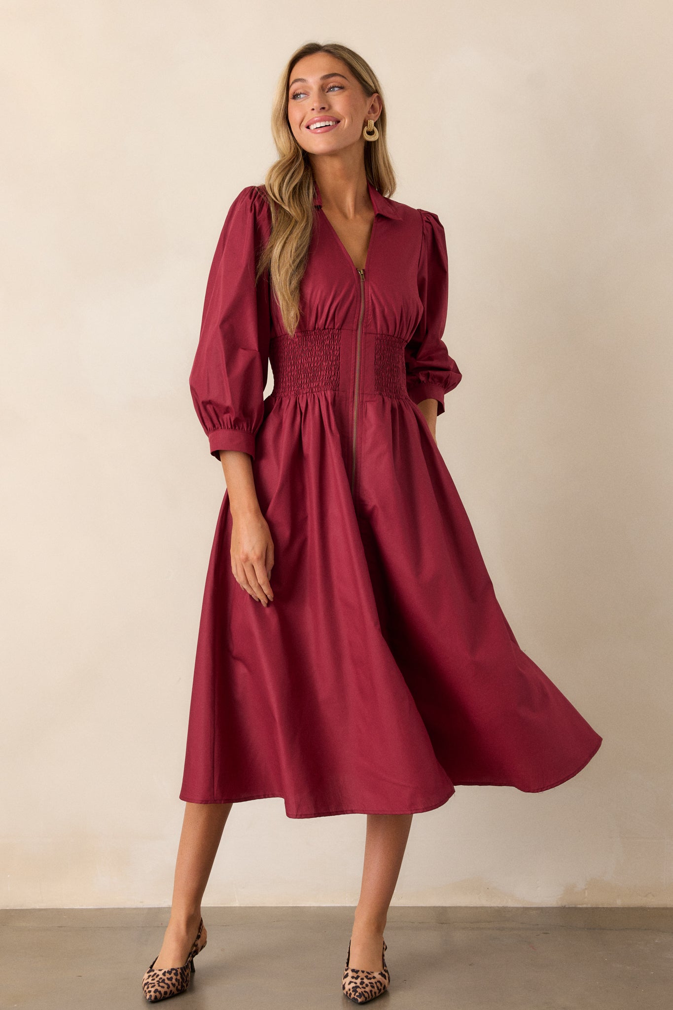 Full view of the dark sangria midi dress featuring a collared v-neckline, 3/4 sleeves with cuff detailing, and a functional front zipper with brassy gold hardware.