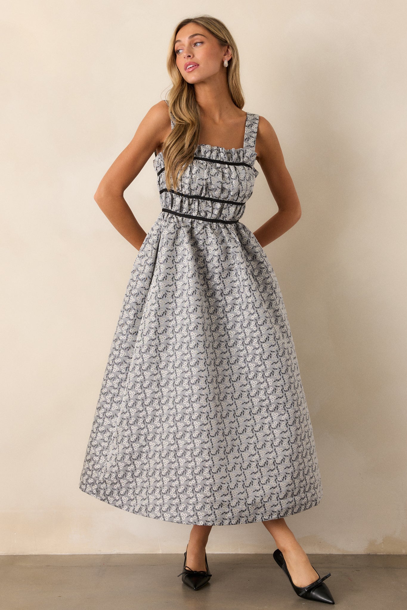 The grey dress displayed in full view, highlighting the mini-length liner and the stylish design details, including the back self-tie bows.