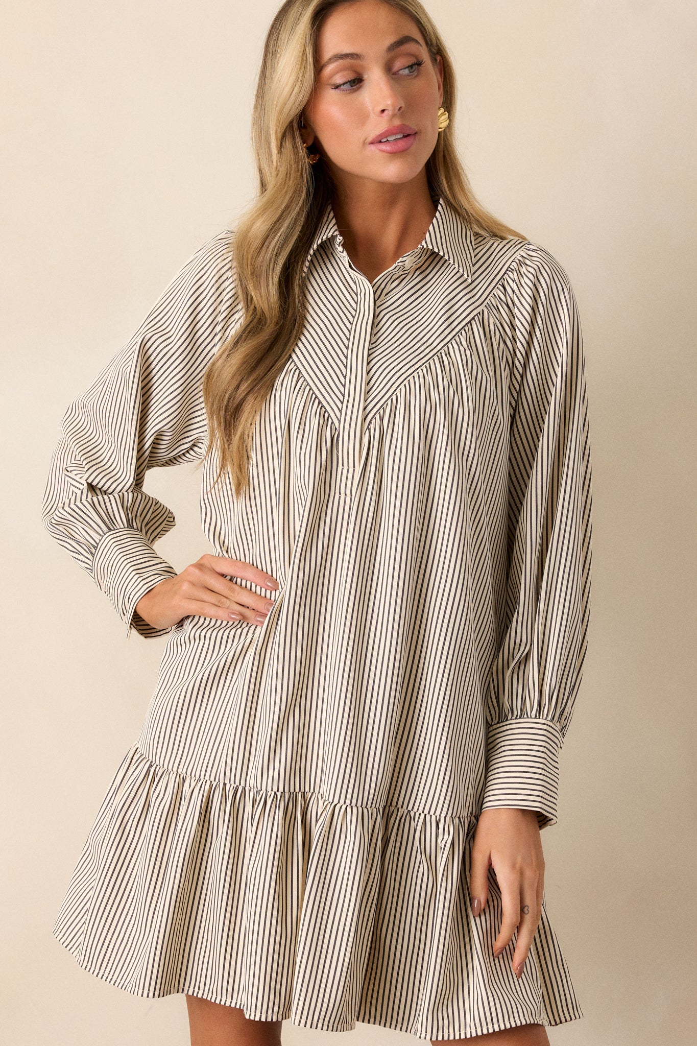 Focus on the sleeves, showcasing the long sleeves with cuff detailing and the vertical stripe pattern running along the arm.