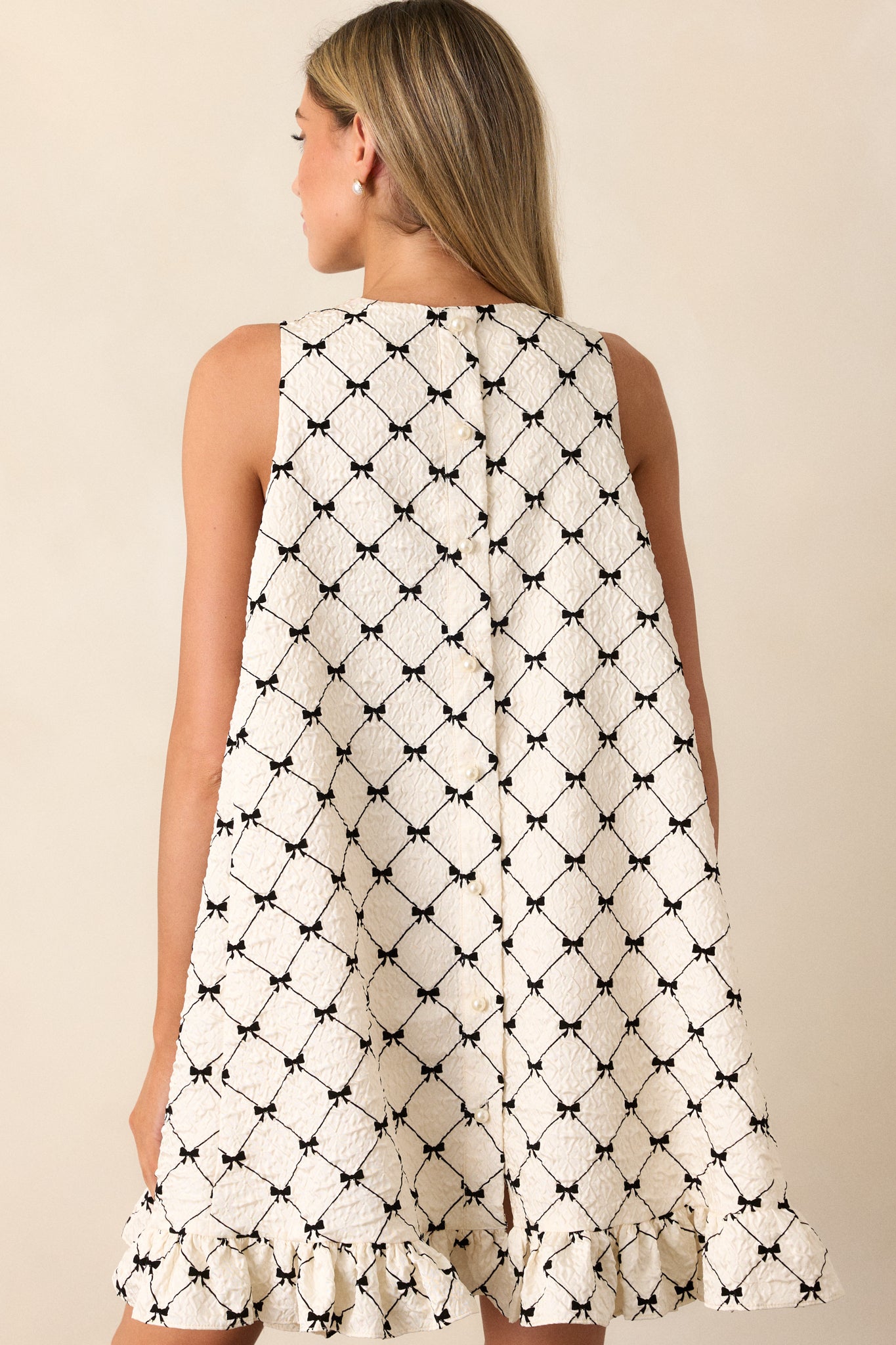 Detailed back view of the geometric bow pattern on the fabric, showcasing the texture and intricate design.