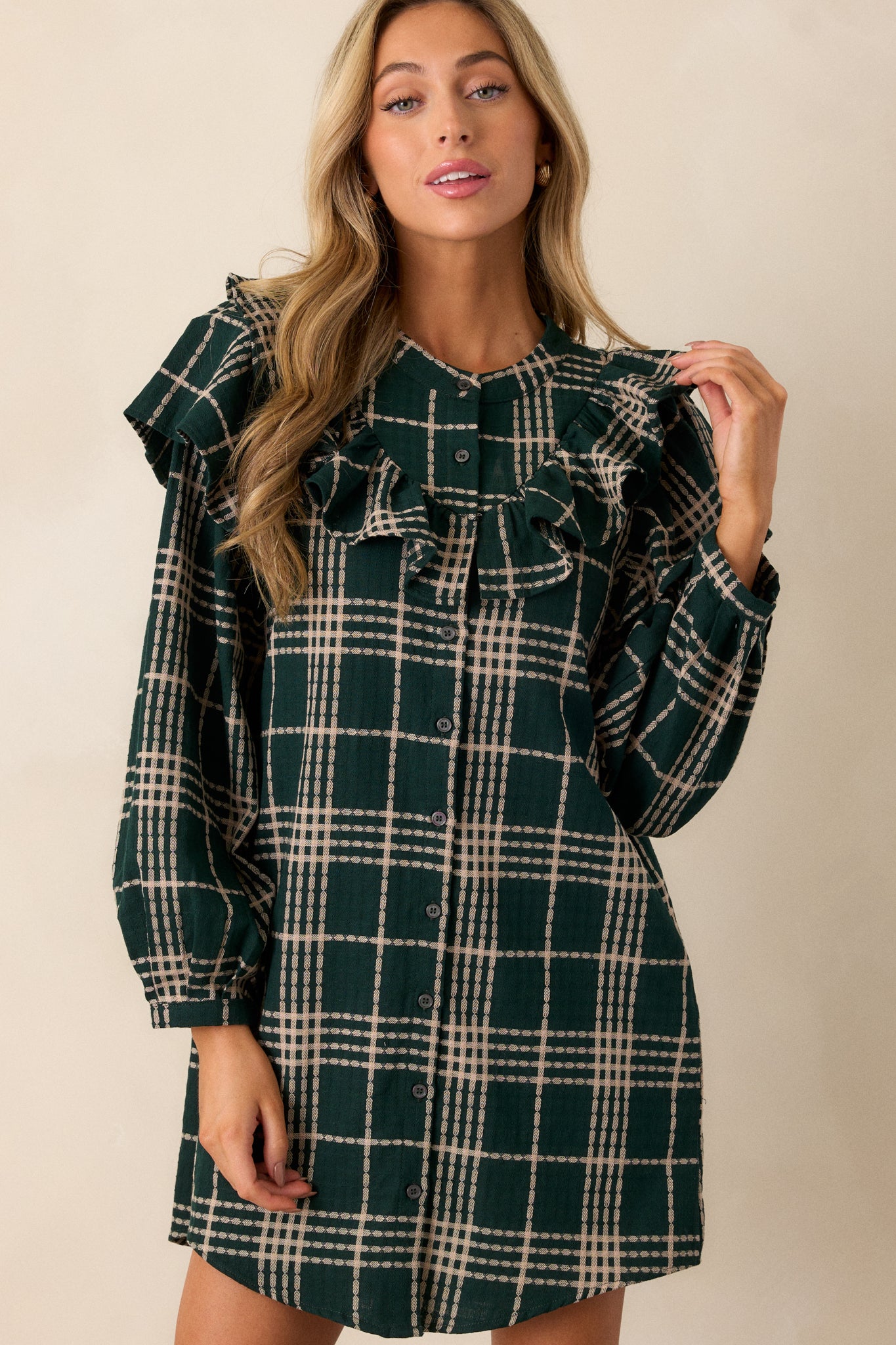 A cropped view of the front, emphasizing the button front design and the neat alignment of the plaid pattern.