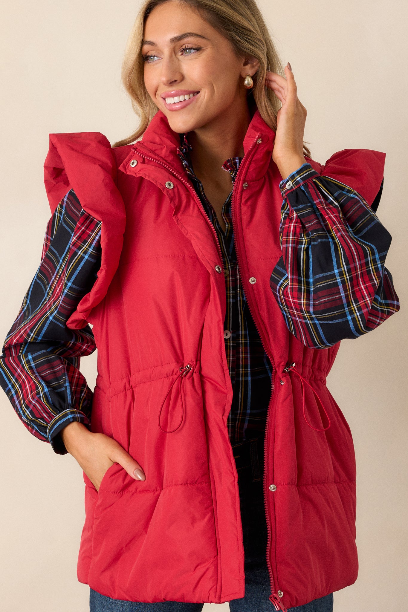 Detailed shot of the fluffy flutter sleeve on the red puffer vest, emphasizing its soft, voluminous texture.