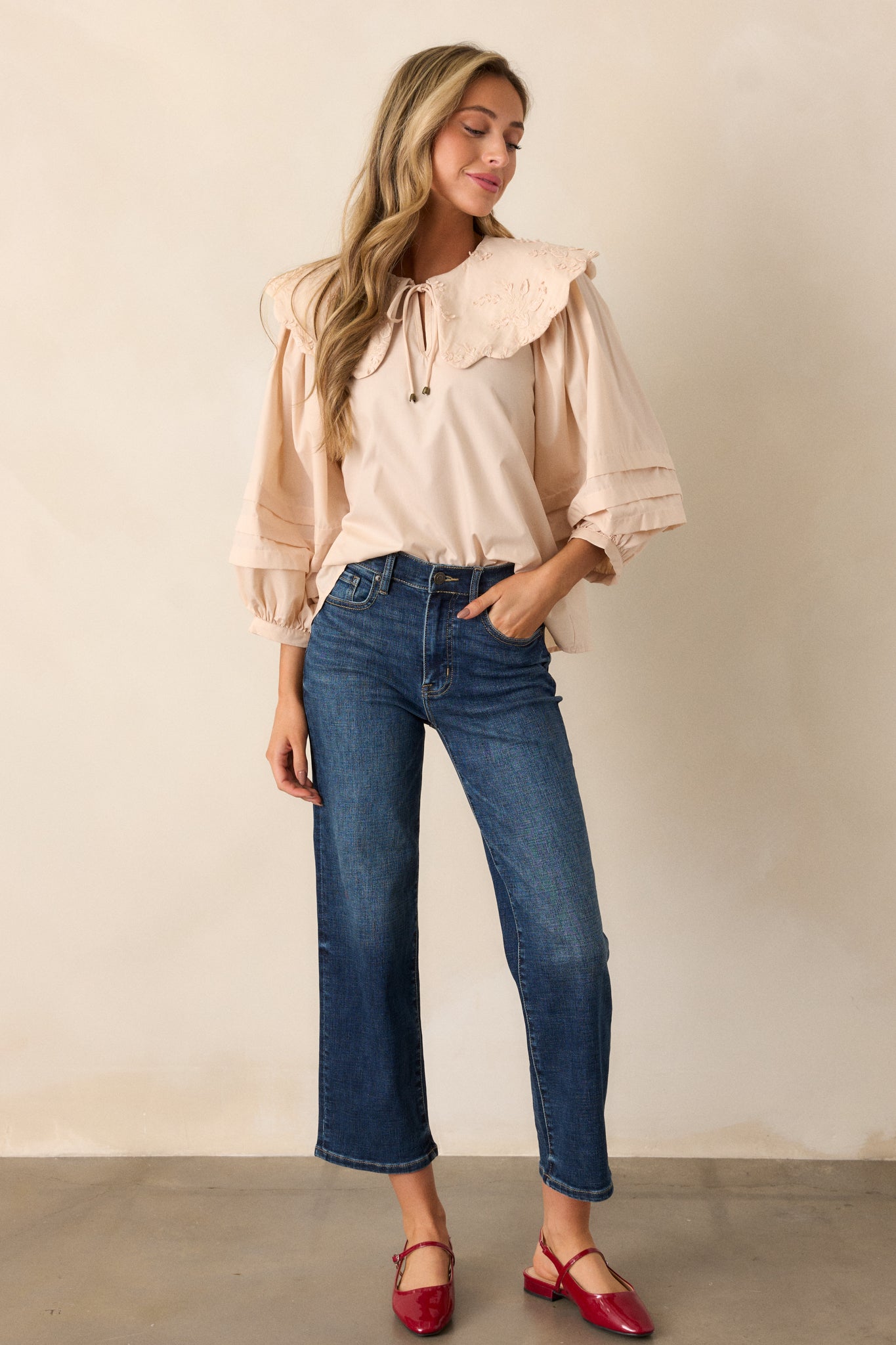 Full-length view of dark wash straight-leg jeans, highlighting the high waist design and relaxed fit from waist to ankle.