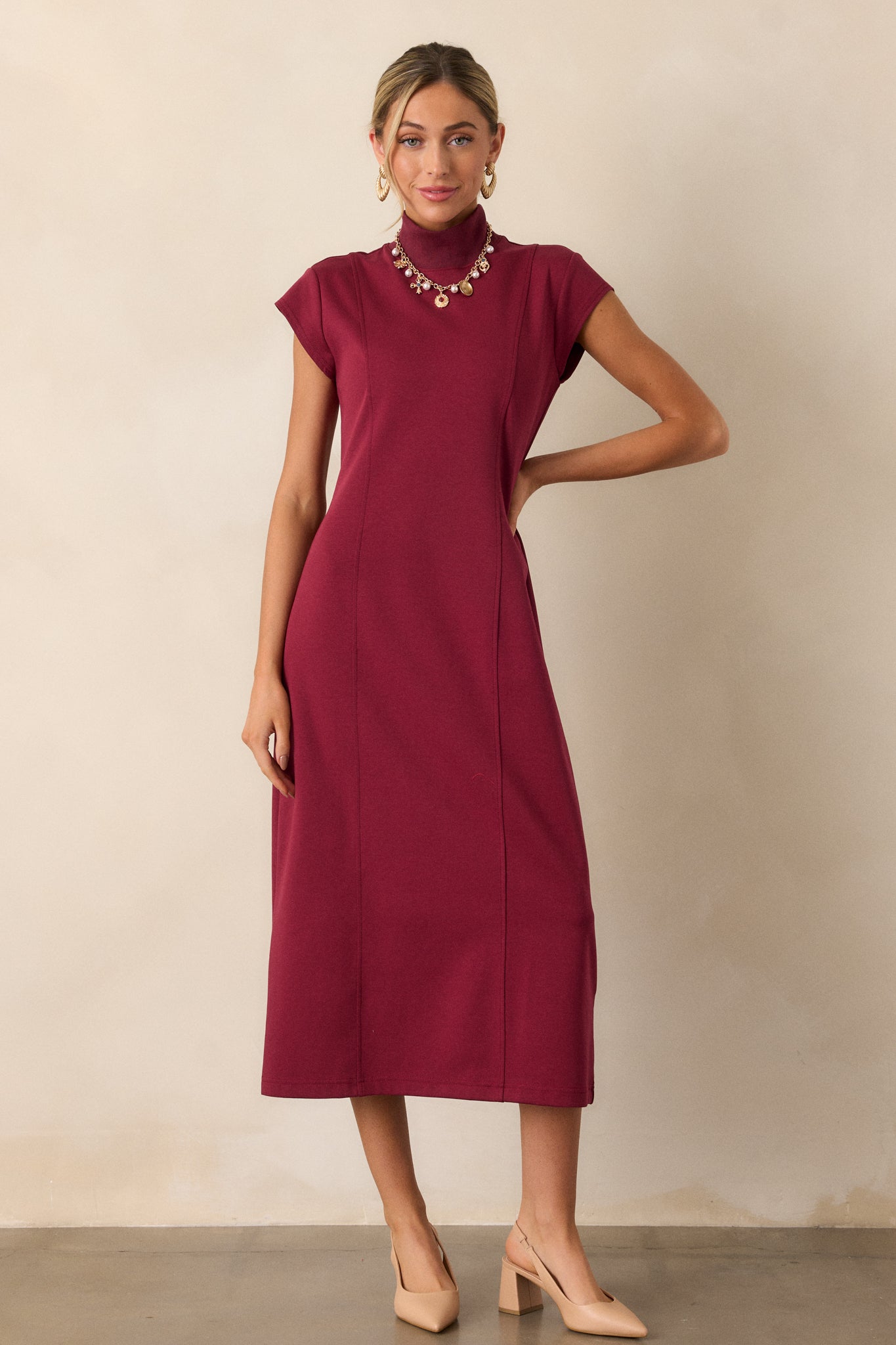 The dress is shown from the front, capturing the minimalistic design and fitted bodice that enhances the overall silhouette.