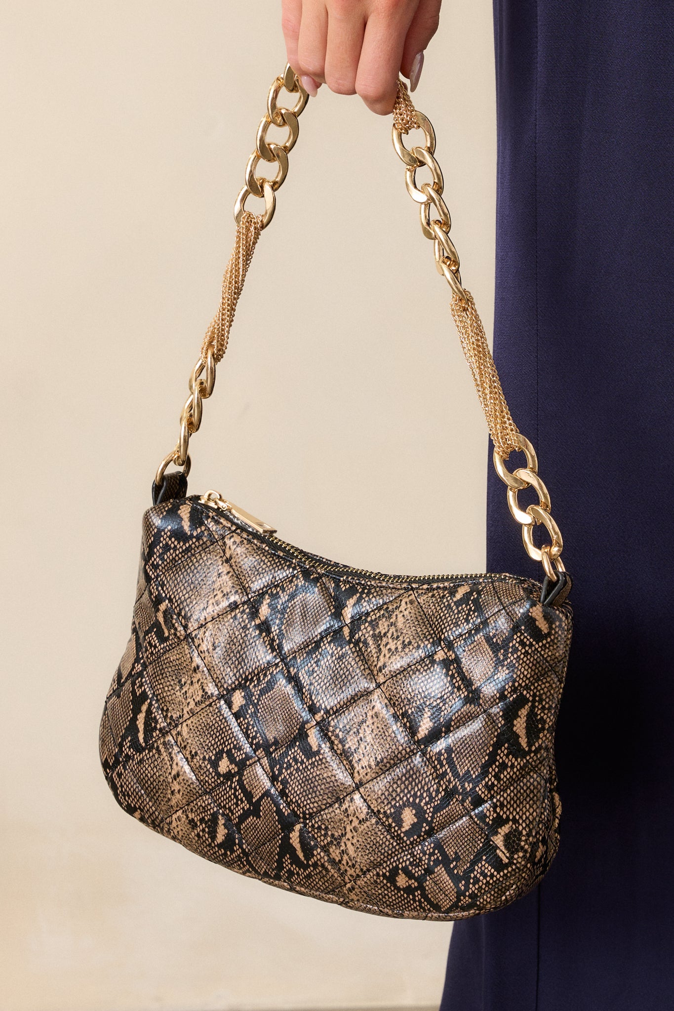 Detailed image of the open zipper closure, revealing the built-in zipper pocket inside the snakeskin handbag.