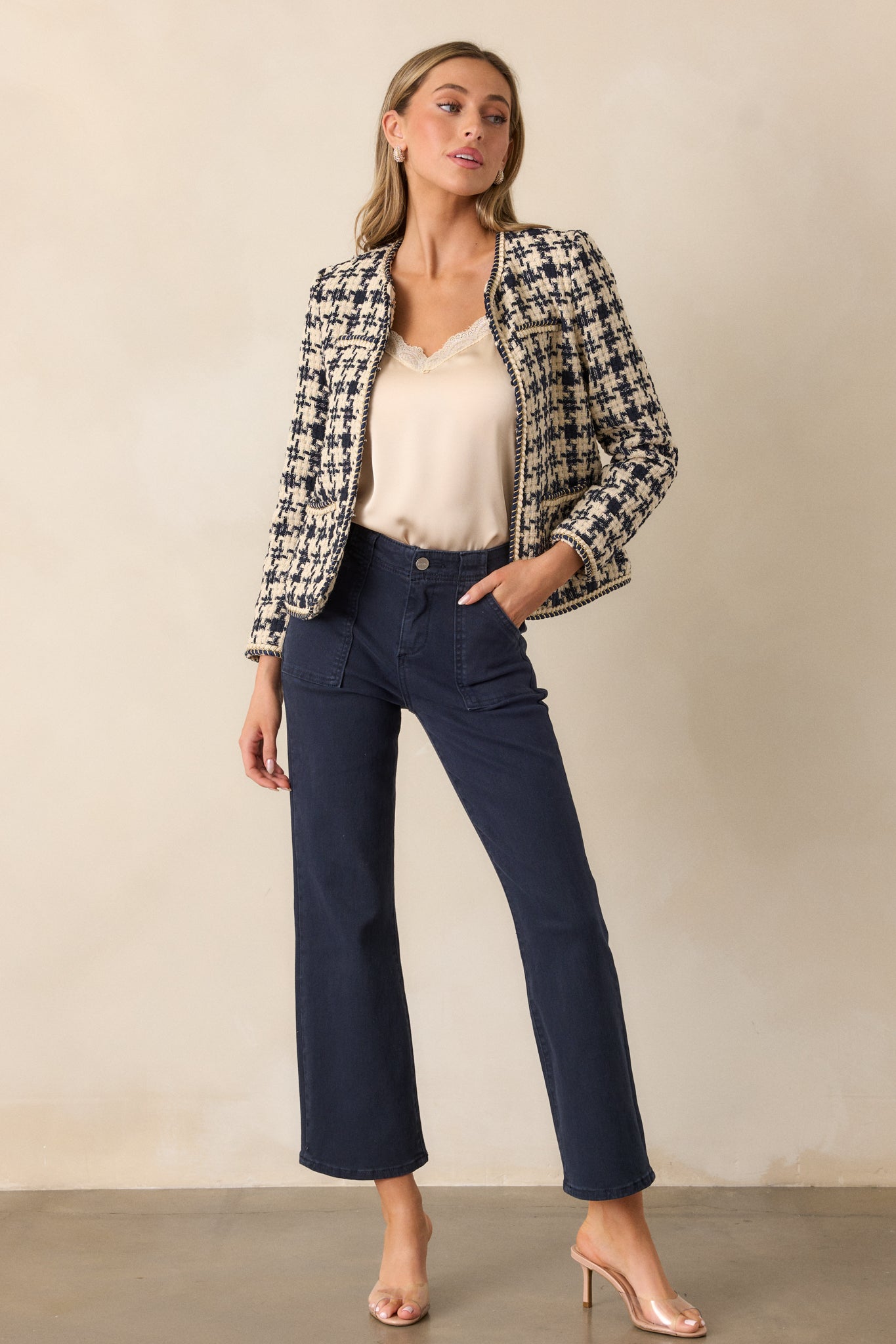 A complete front profile showing the double gold rope twist trim along the jacket’s front and the houndstooth design, with an emphasis on the jacket’s boxy fit and elegant detailing.