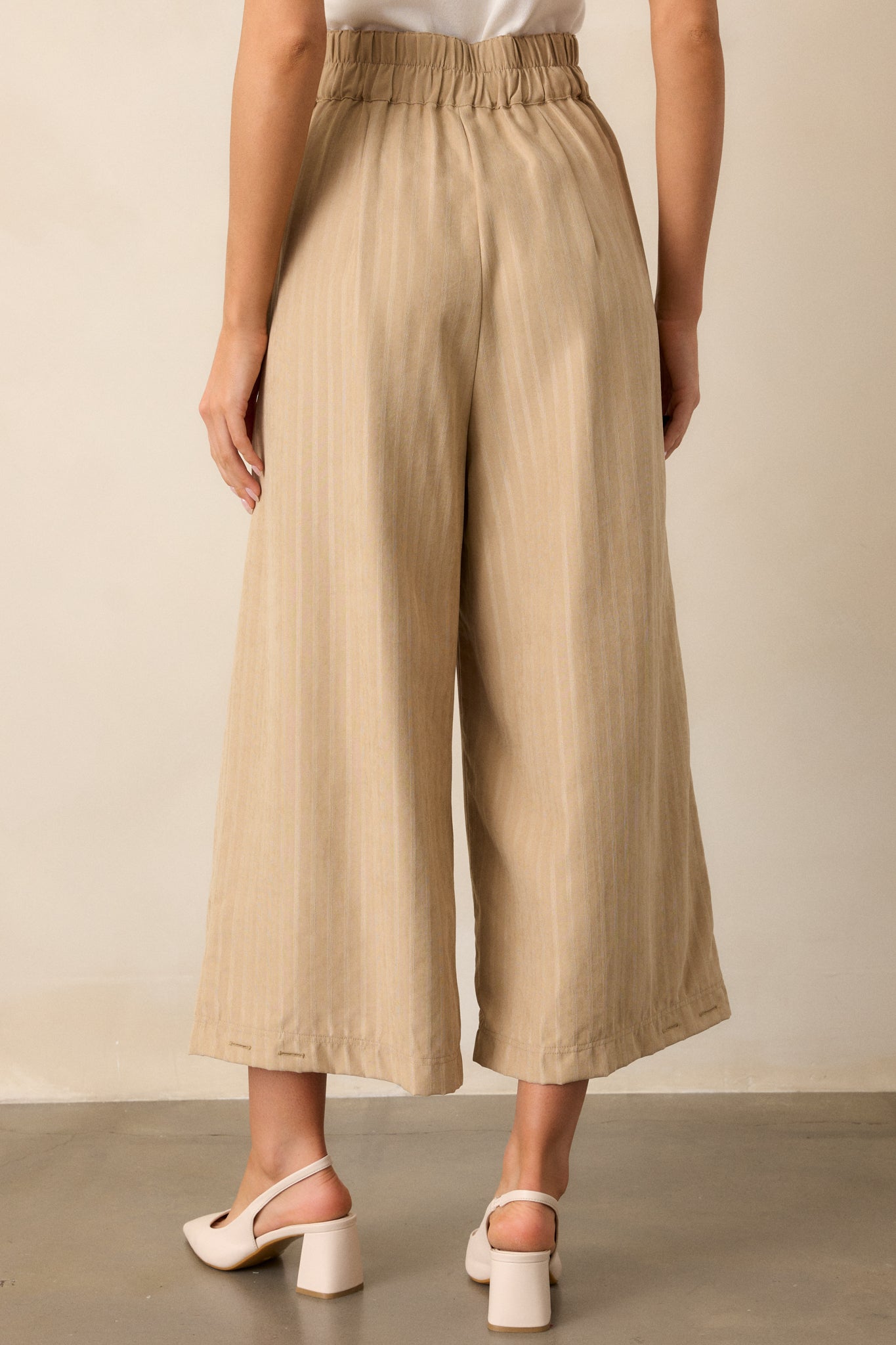 Back view of the pants, showing the functional back pockets and clean high-waisted design.