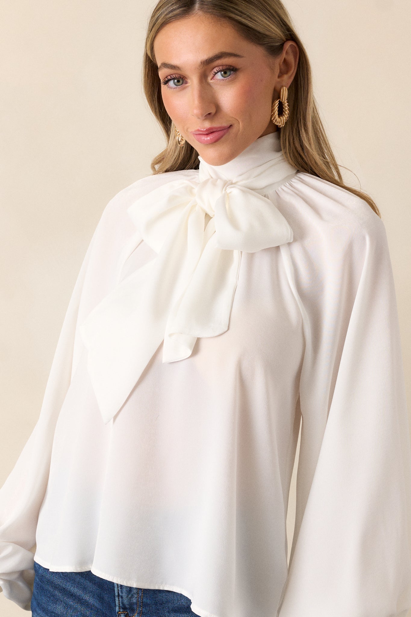 Another cropped shot focusing on the self-tie around the neck, with the balloon sleeves visible. The relaxed, flowy design of the top gives a laid-back and effortless vibe.