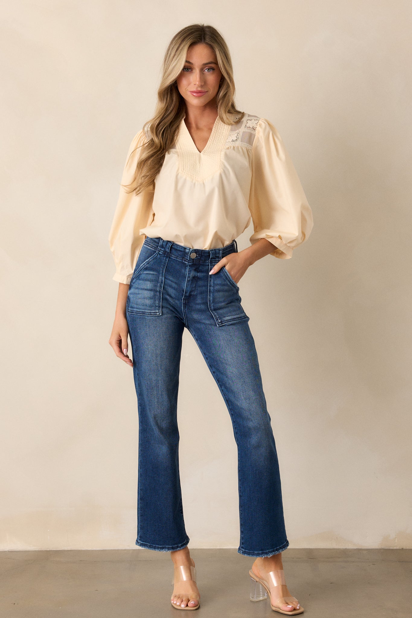 Front view of the dark wash jeans showing the high waisted design and large functional front pockets, emphasizing the classic fit.