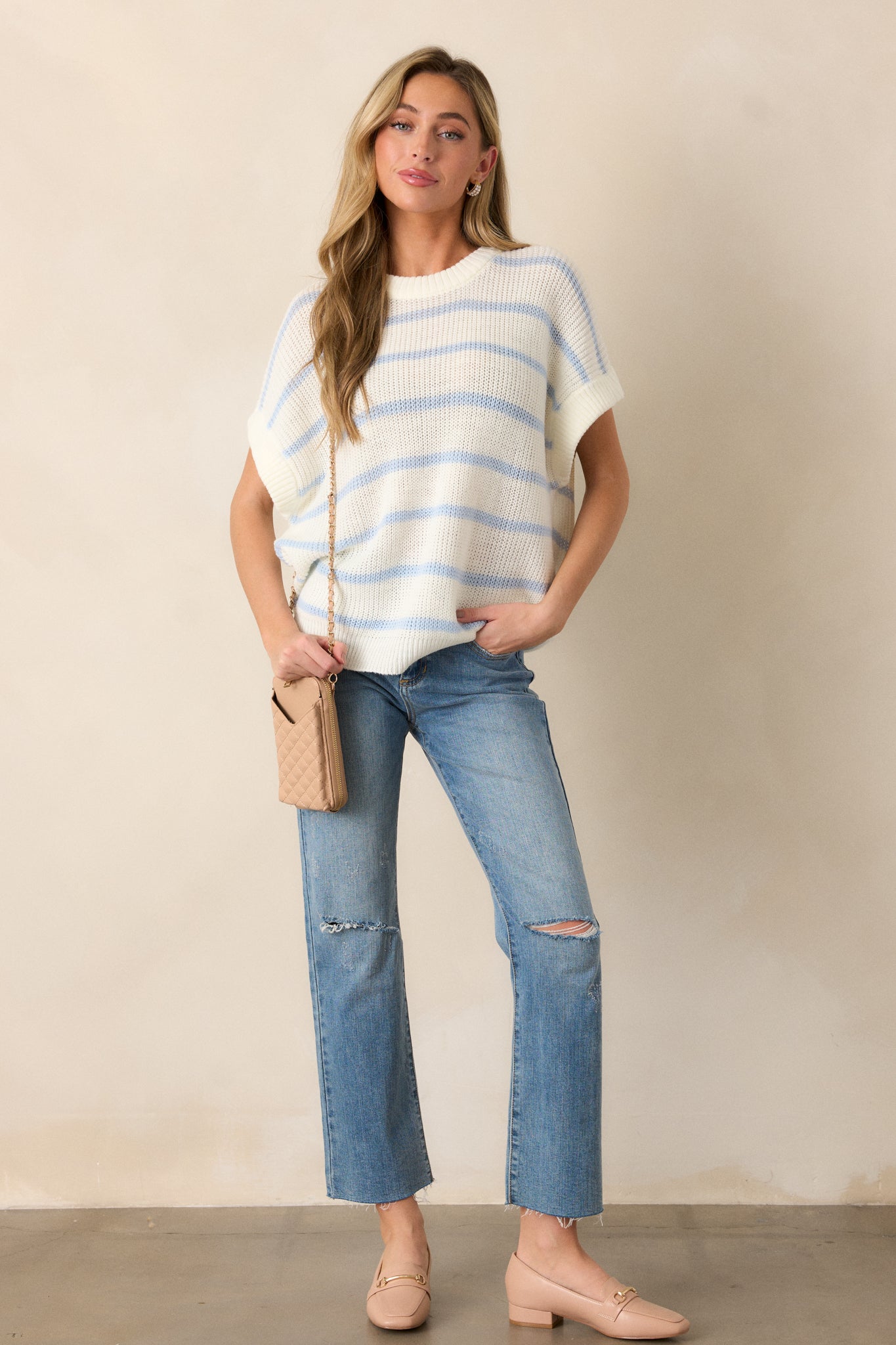 A full-body angle showcasing the top’s soft and relaxed fit, short oversized sleeves, and the stylish striped design. The ribbed neckline and bottom hem add texture to the simple, yet cozy look.