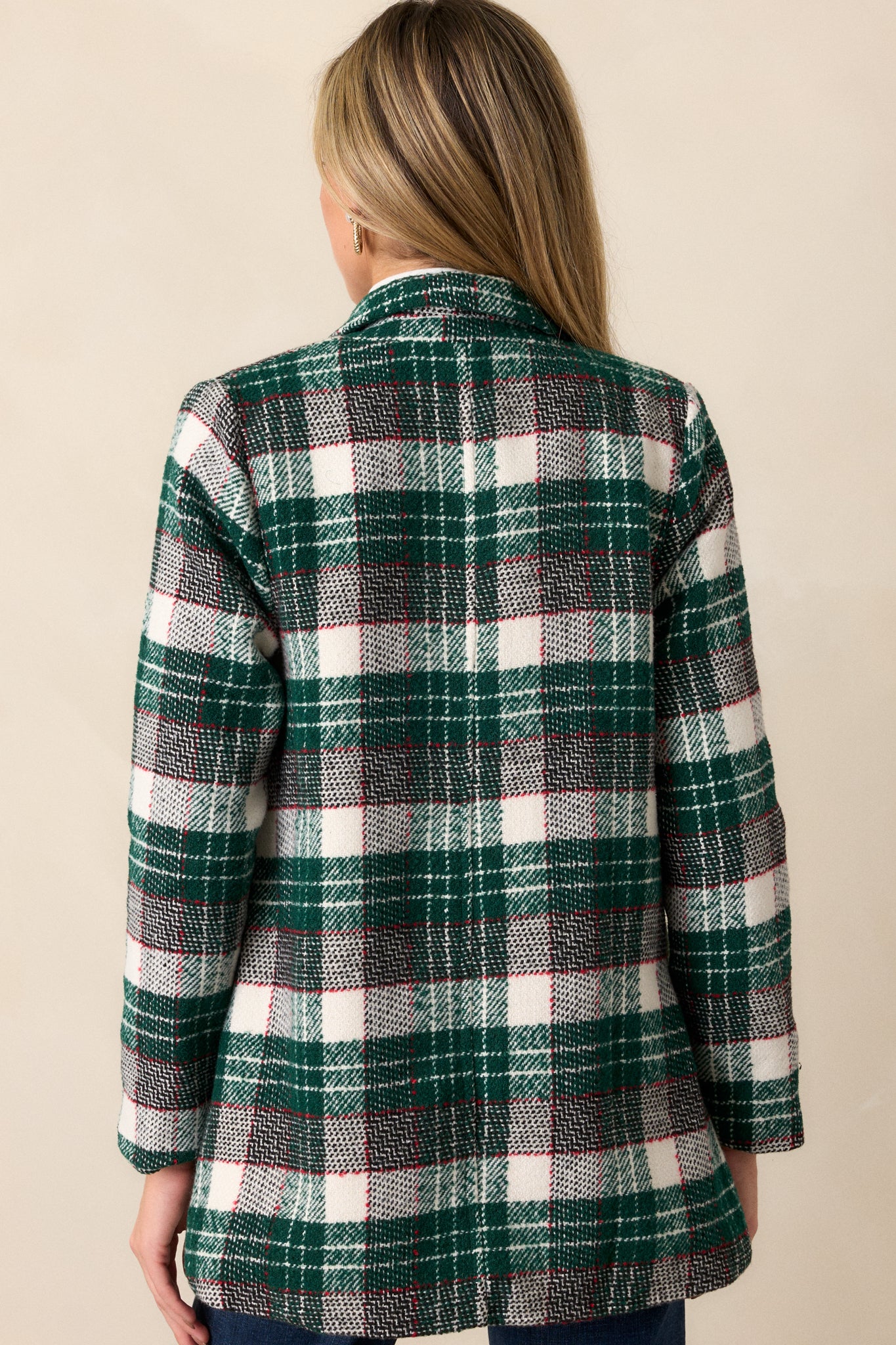 View of the back of the coat, featuring the smooth, tailored fit, with the fabric flowing naturally down from the shoulders to the hemline.