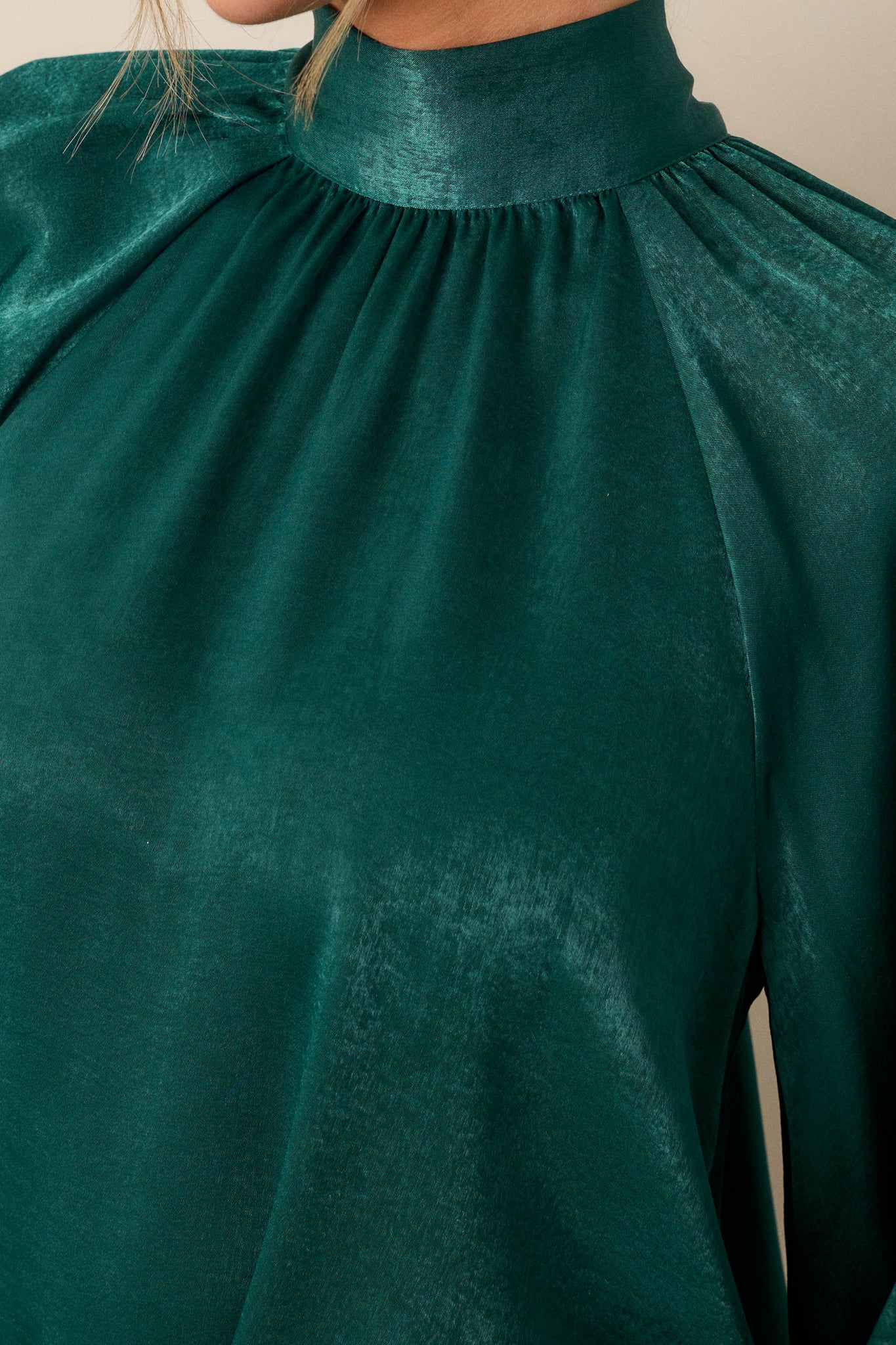 Close-up of the fabric texture, emphasizing the flowy fit and the intricate details of the balloon sleeves and cuffs.