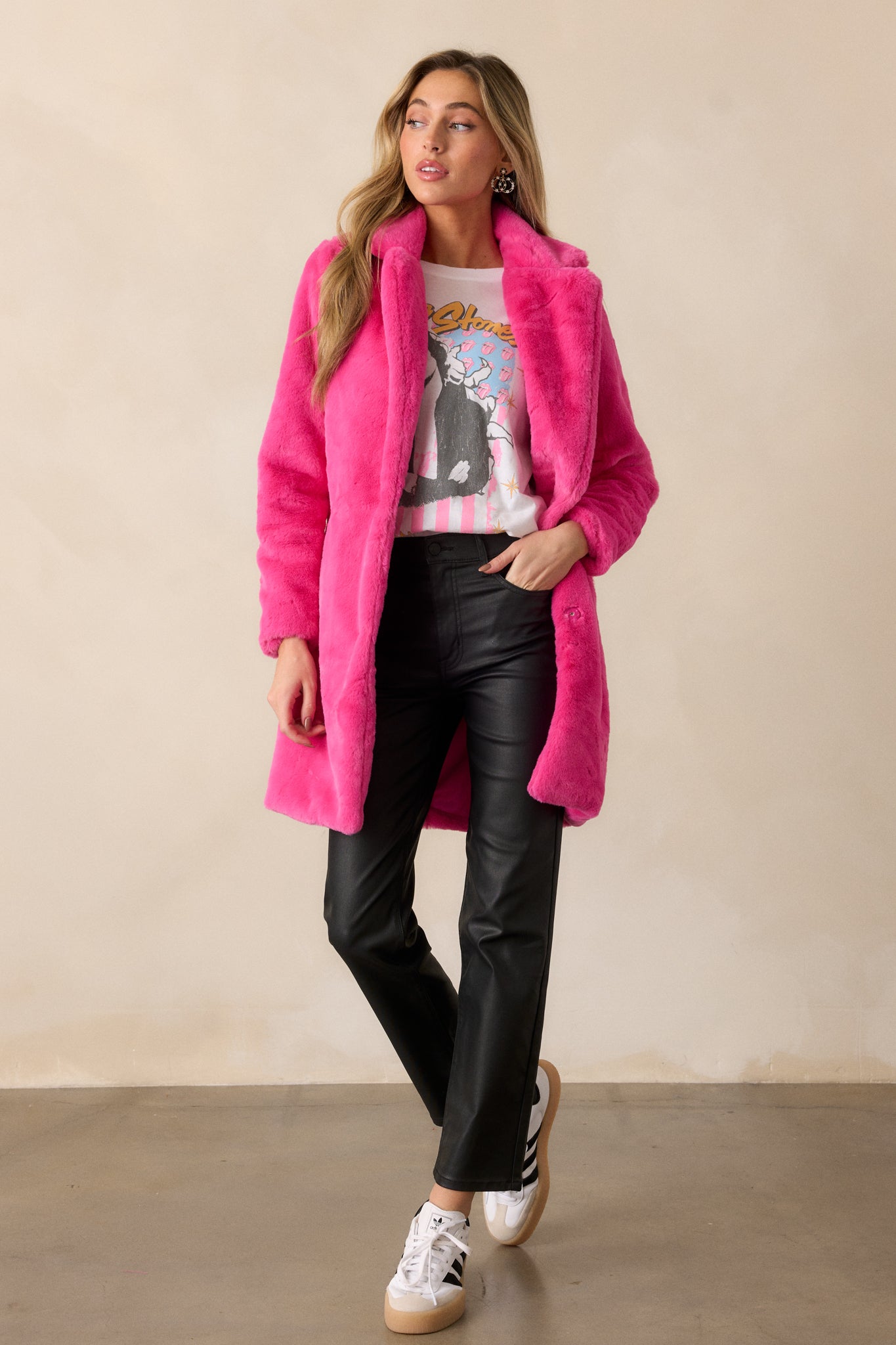 A front-facing view of the coat, emphasizing the functional hip pockets and the luxurious faux fur finish.