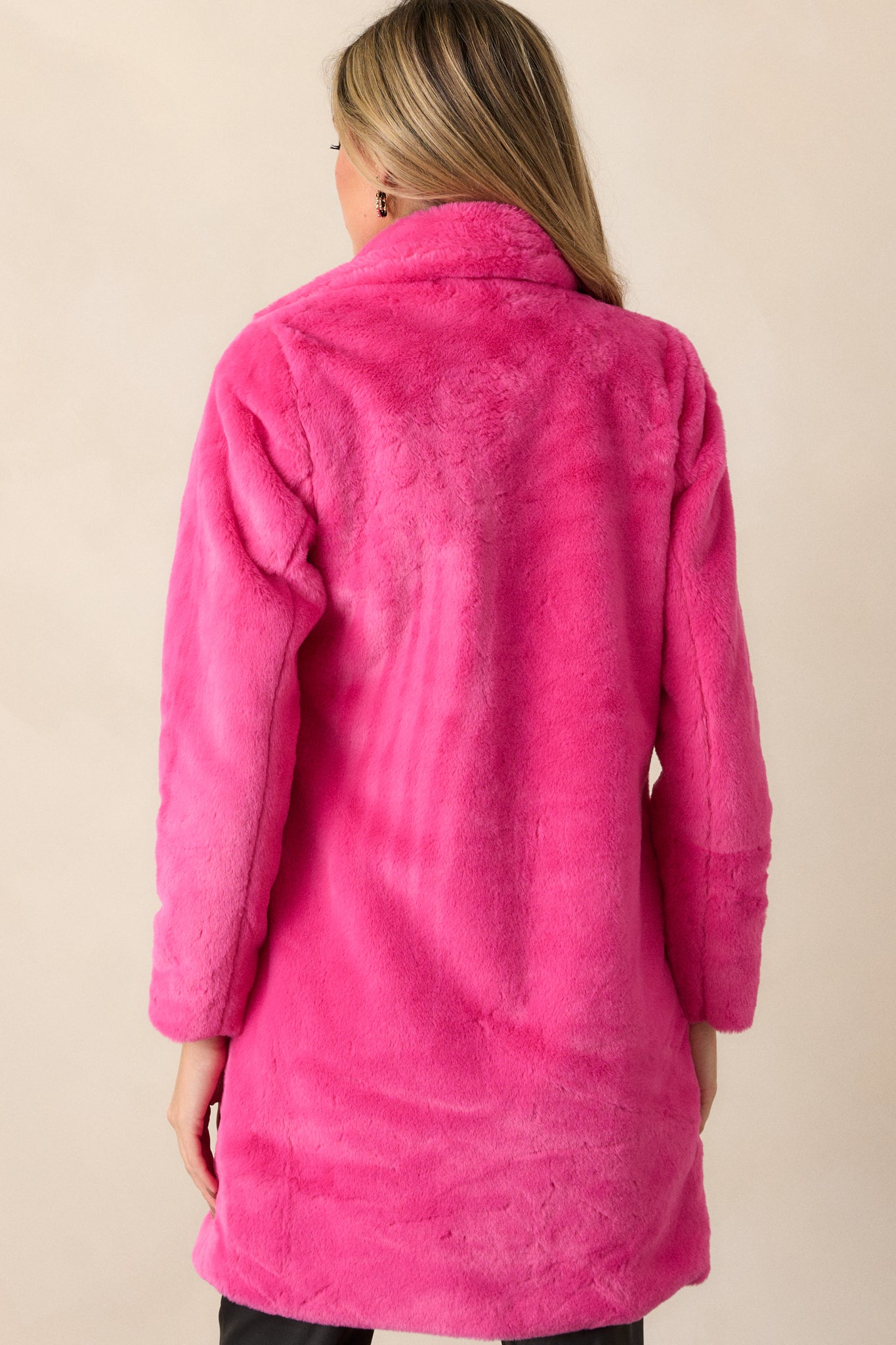 View of the back of the coat, featuring the continuous faux fur exterior and the long, smooth silhouette down to the hem.