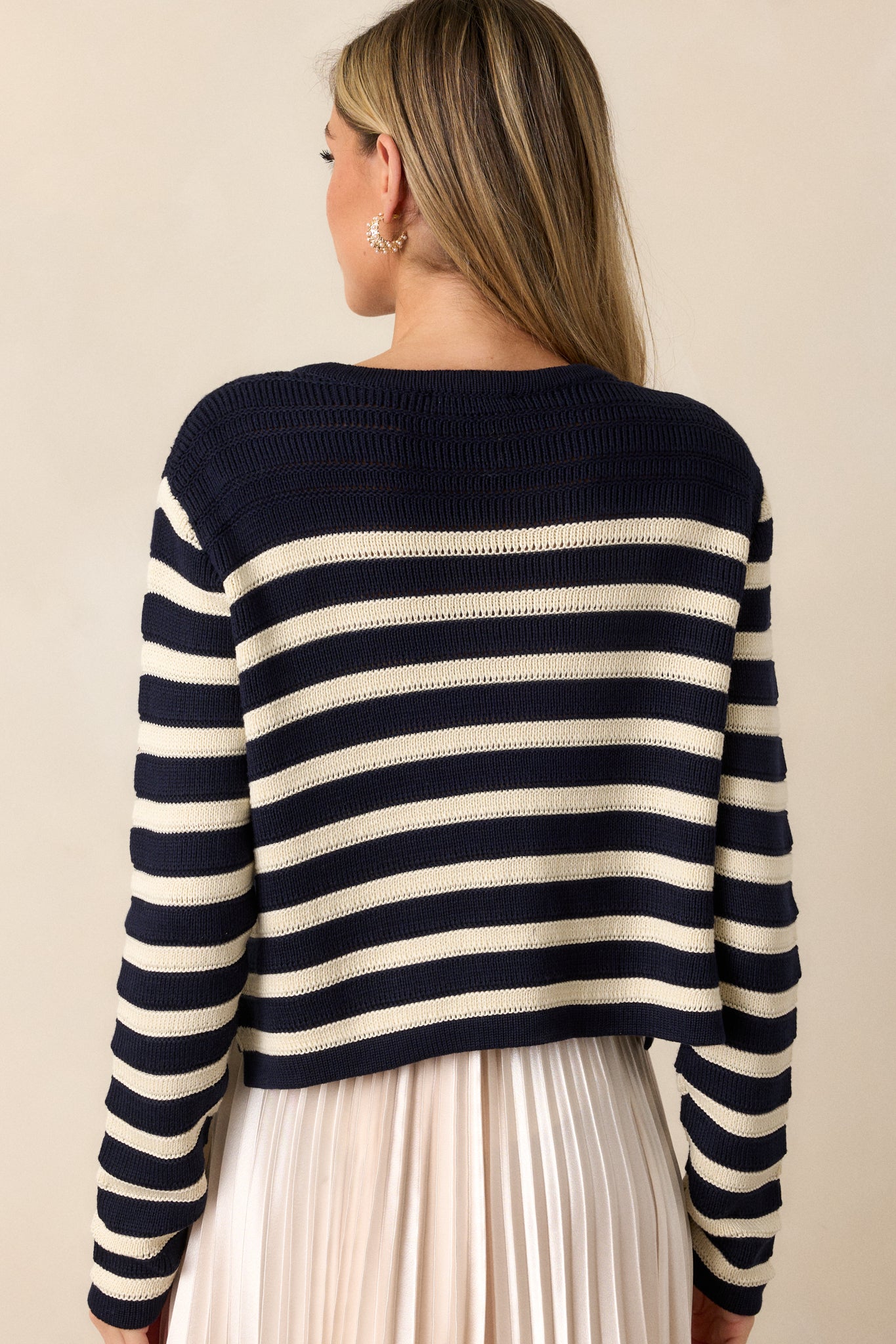 Back view of the cardigan, displaying the stripe design running horizontally across the back with the long sleeves visible from the rear angle.