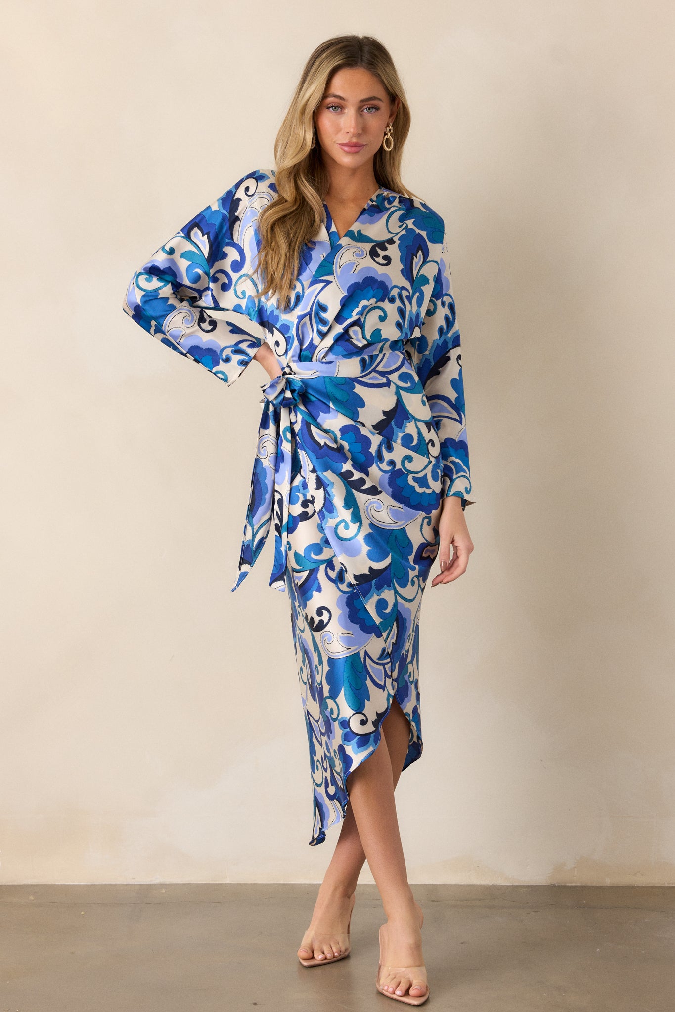 Front view of the dress captured in natural light, emphasizing the vibrant blue color, v-neckline, and the stylish wrap design with the belt.