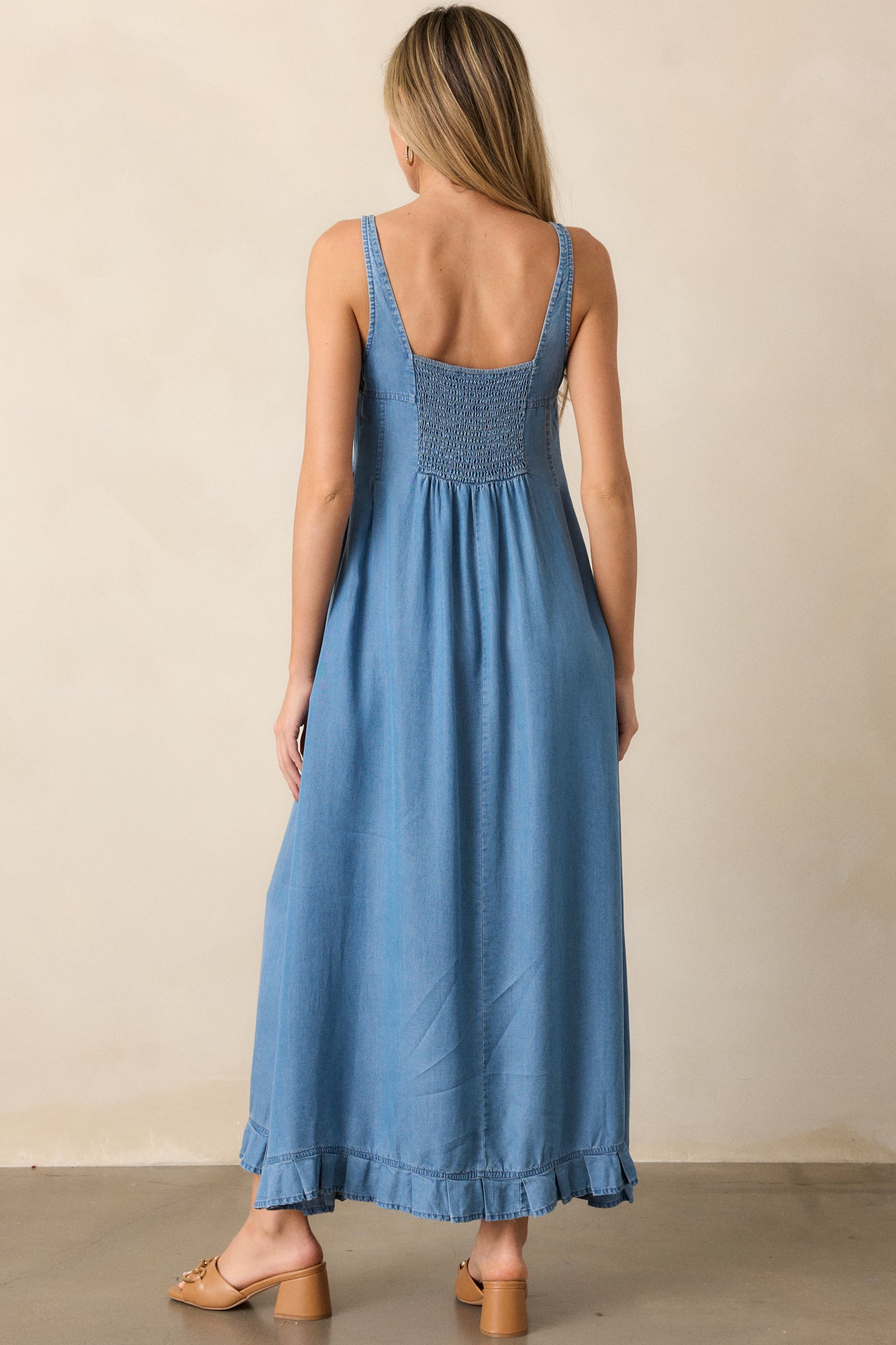 View of the back of the dress, featuring the smocked back detail and the smooth, flowing A-line skirt.