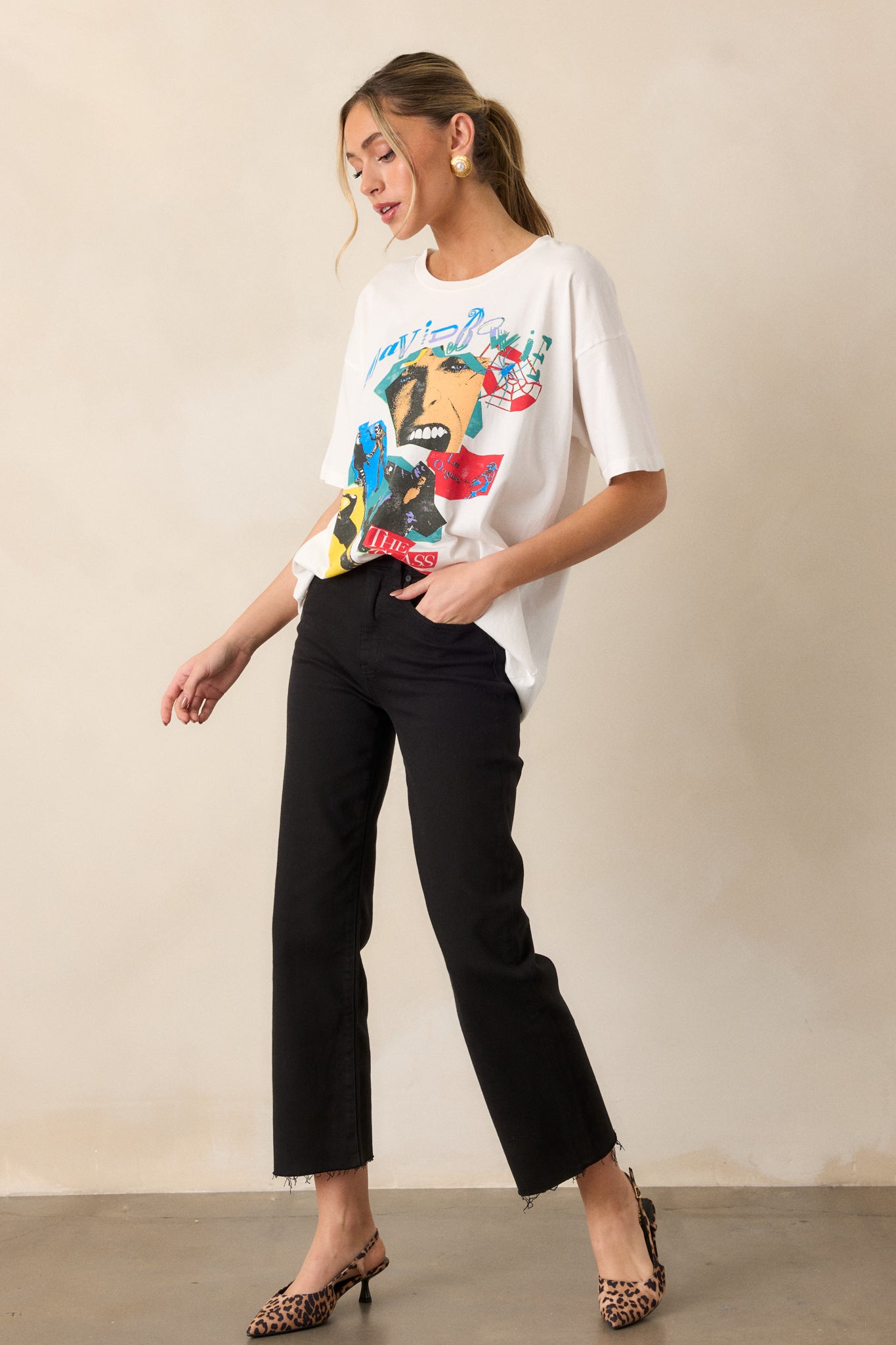 A side view of the tee, showing the fit of the shirt with the short sleeves and a partial look at the front graphic, focusing on its casual style.