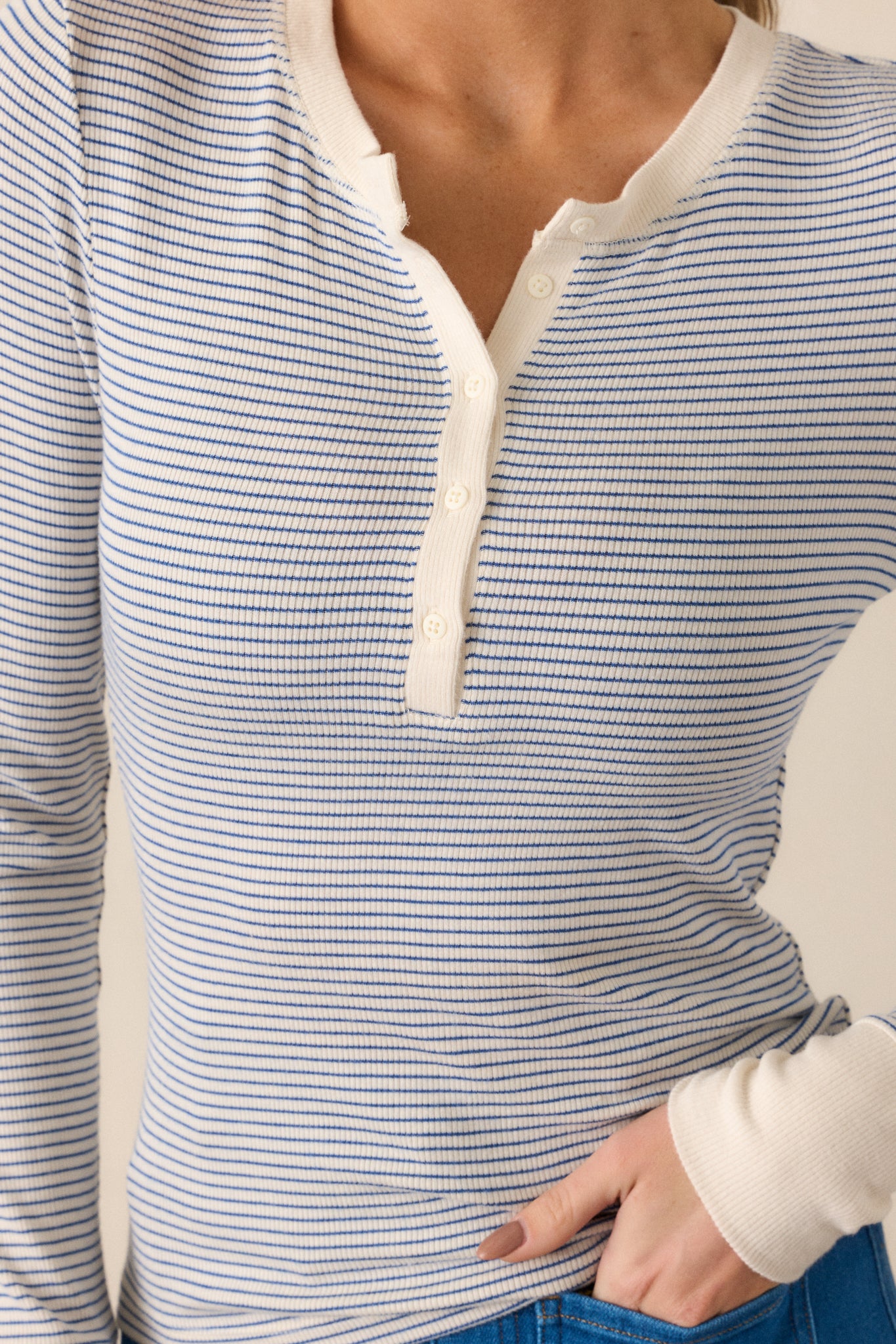 Close-up of the top’s fabric texture, highlighting the ivory henley neckline, buttons, and intricate blue and ivory stripe pattern.