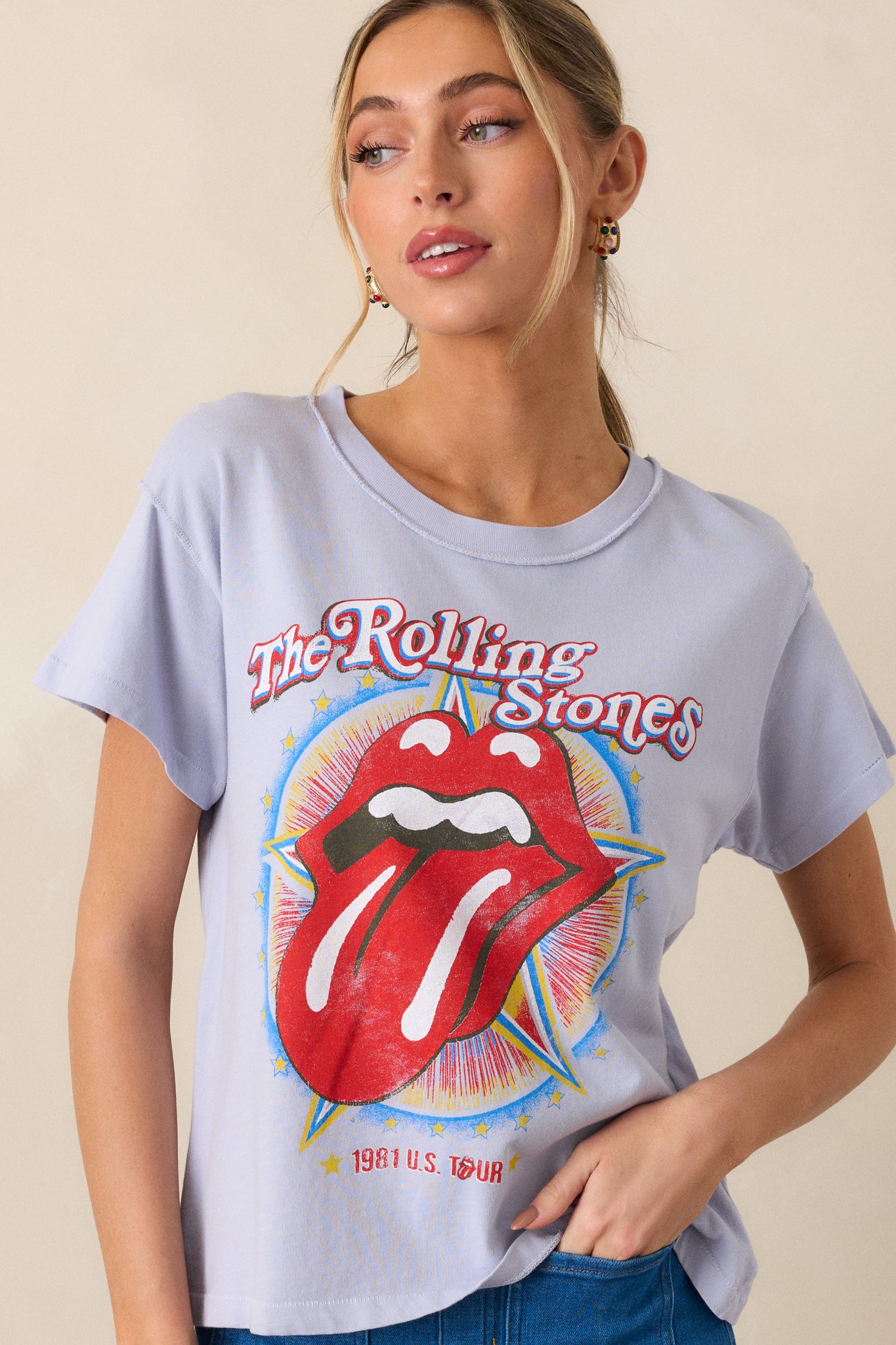 A front view of the lavender top from a different angle, featuring the short sleeves, round neckline, and the "Rolling Stones 1981" graphic on the chest, giving the top a laid-back, nostalgic vibe.